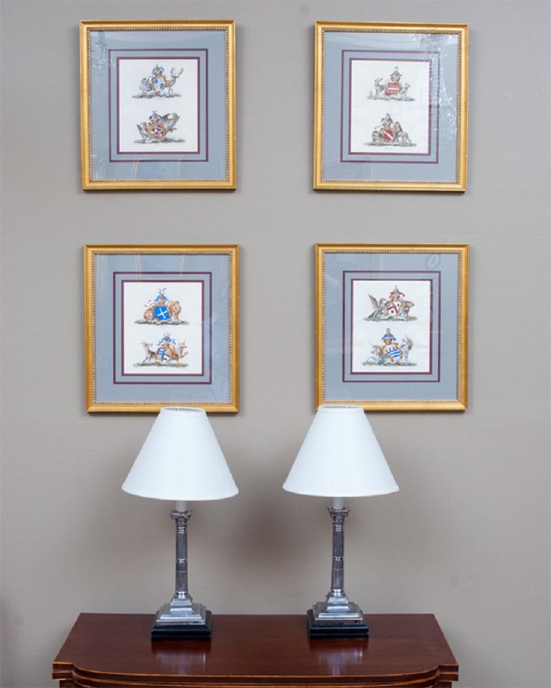 These hand colored engravings are old English crests/coats of arms -- two in each frame: Ashburnham & Effingham; Portland & Manchester; Northington & Radnor; and Peterboro & Hamford.. Based on well-researched information mounted on the back of each,