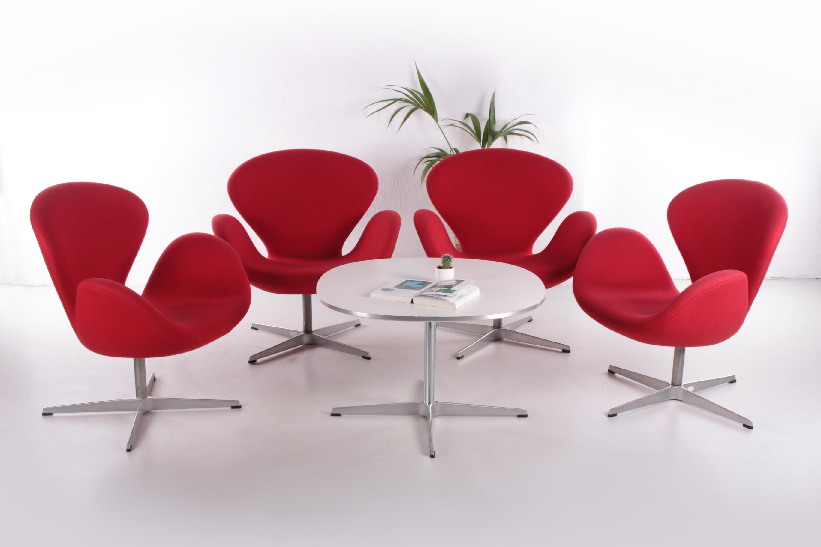 This is a beautiful set from 2001 in a more than perfect condition. Fritz Hansen Swan lounge chair designed by Arne Jacobsen in 1958. Red fabric, aluminum satin polished base.
Arne Jacobsen

Arne Jacobsen (11 February 1902 – 24 March 1971) was a