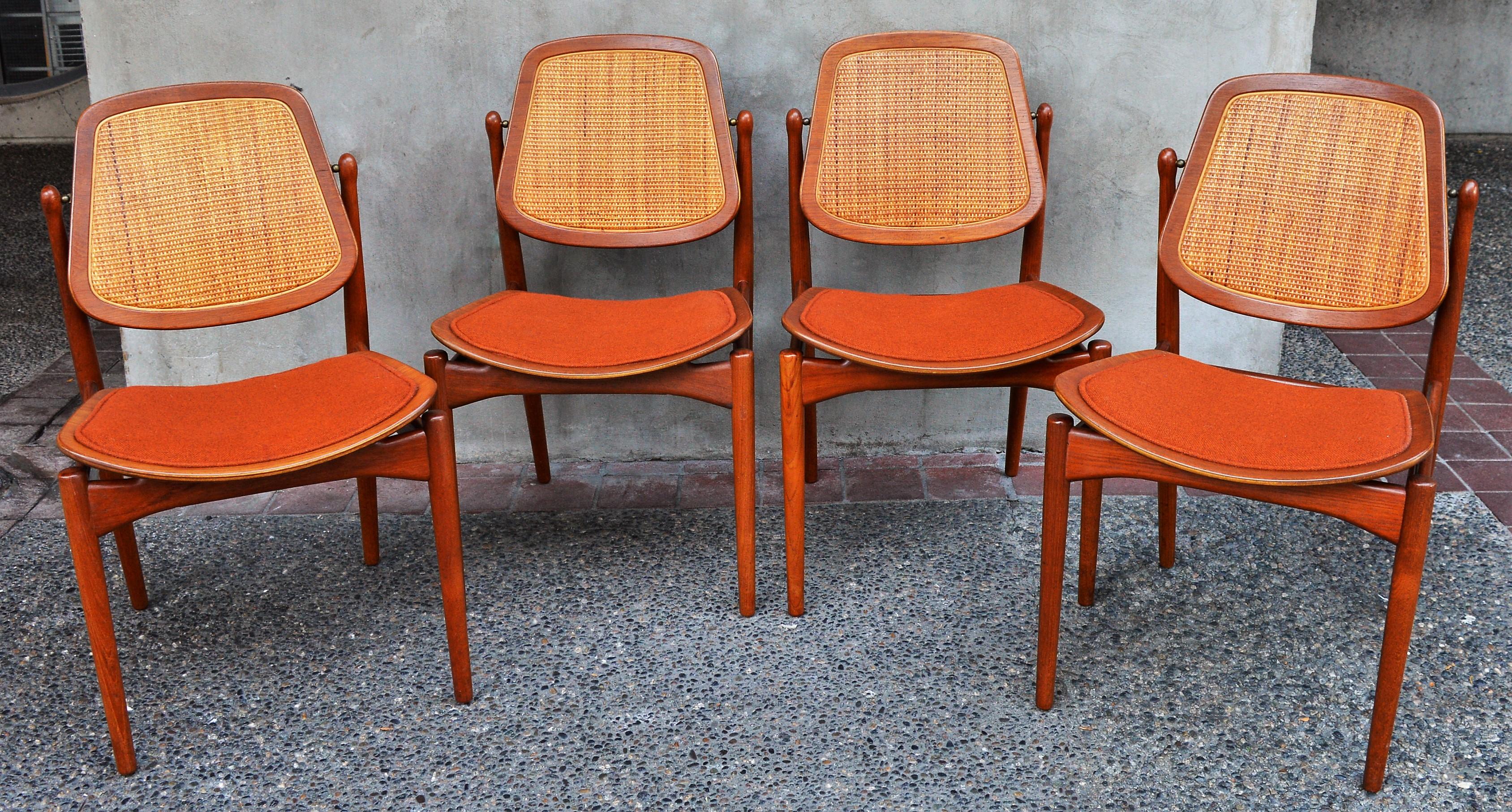 These amazing early 1950s Danish Modern teak dining chairs were designed by Arne Vodder for France & Daverkosen. Featuring sculpted details throughout - the ball carved tops of the back legs that frame and support the shield shaped caned backrests,