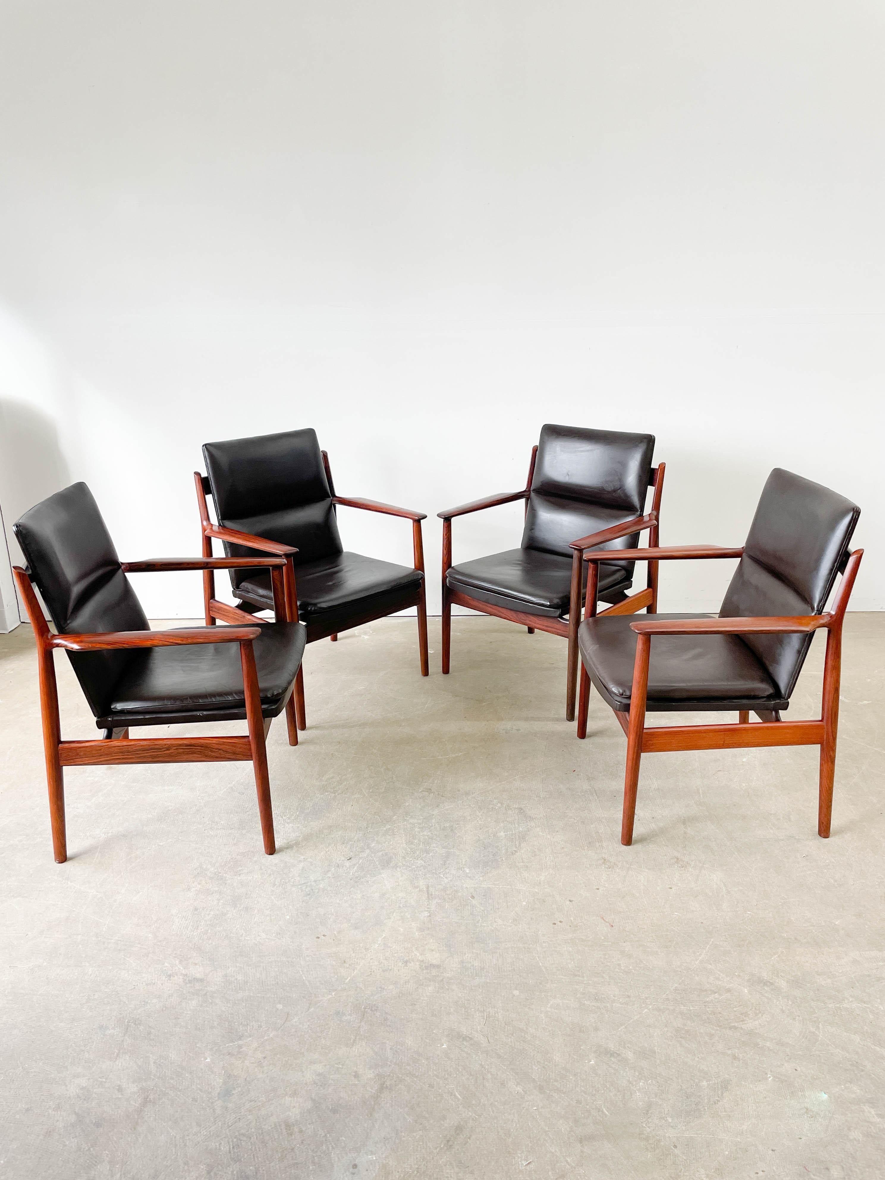 Beautifuly sculpted rosewood frame armchairs designed by Arne Vodder and made by Sibast Mobler in the 1960s. Excellent comofrt with ample armrests and built in lower back support. Solid Brazilian Rosewood frames have exquisite grain and the dark