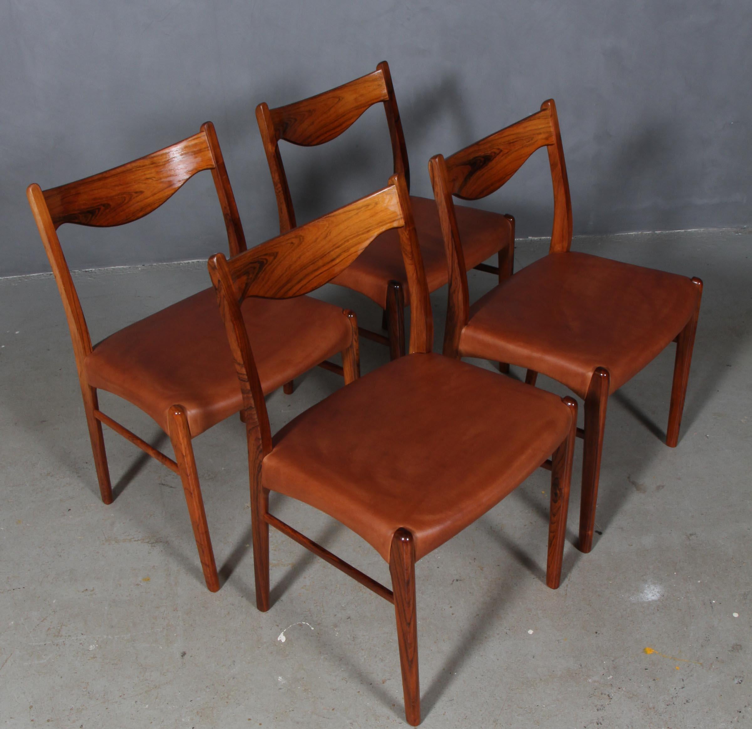 Four dining chairs designed by Arne Wahl, model GS61 for Glyngore Stolefabrik. 

Chairs crafted of solid rosewood with new upholstered seats in tan aniline leather.