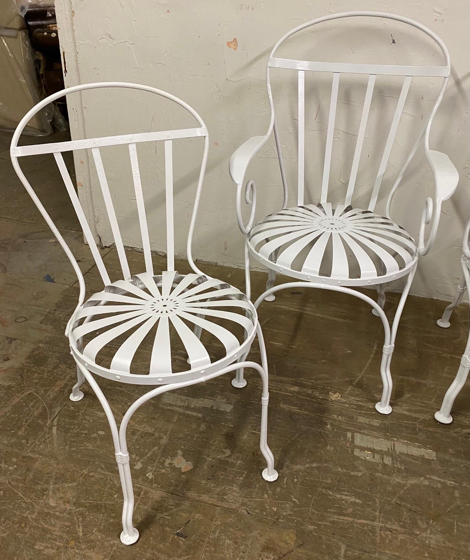 Set of 4 Art Deco Francois Carre style French sunburst garden dining chairs -- 2 arm chairs and 2 side chairs painted white. Wonderful to use for outdoor dining chairs, patio or garden chairs. Perfect chairs for a small kitchen table or the corner