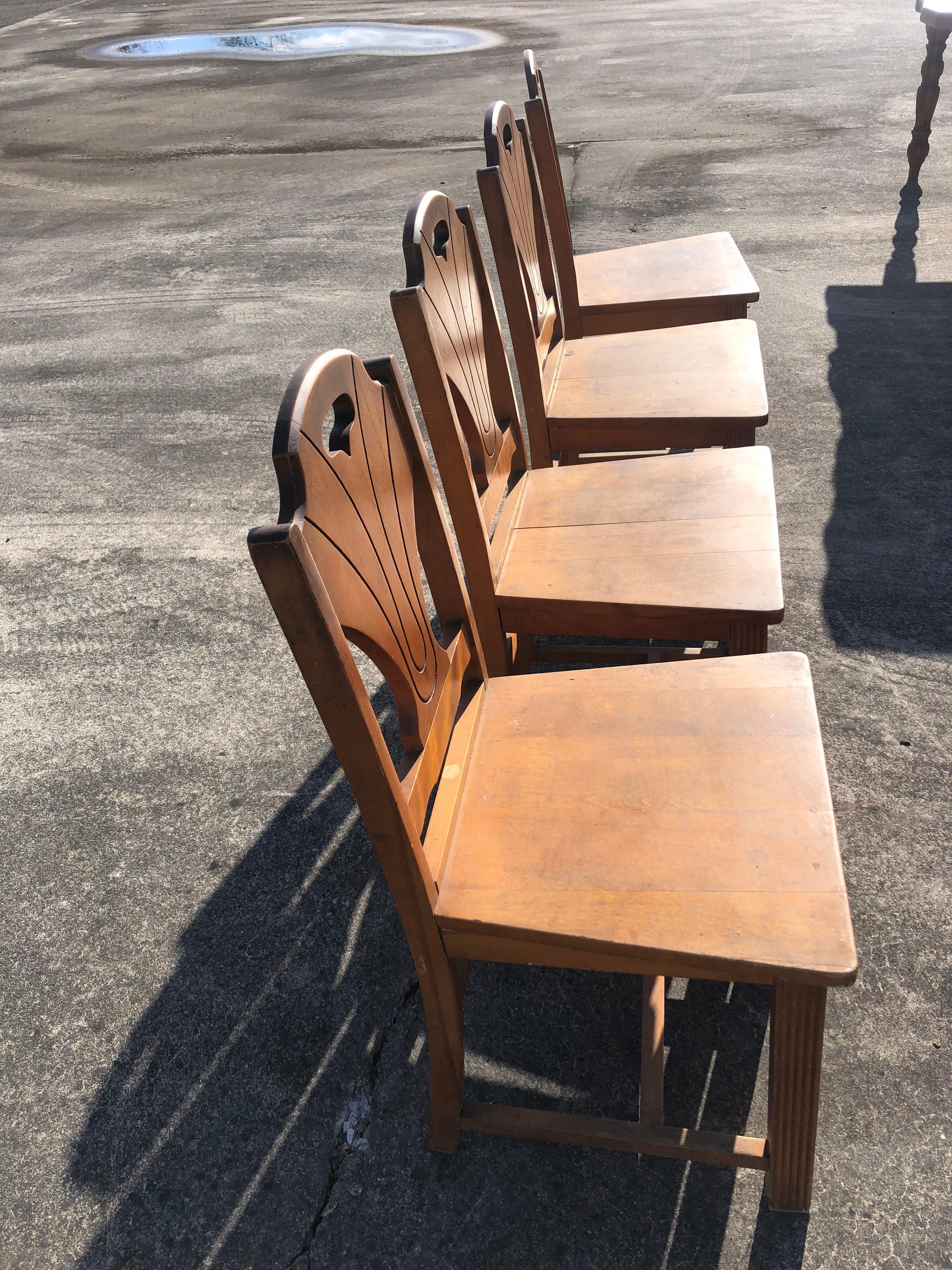 Charming rustic set of 4 informal side dining chairs having sturdy wooden seats and frames with stylish Art Deco style backs and reeded slightly tapering legs.