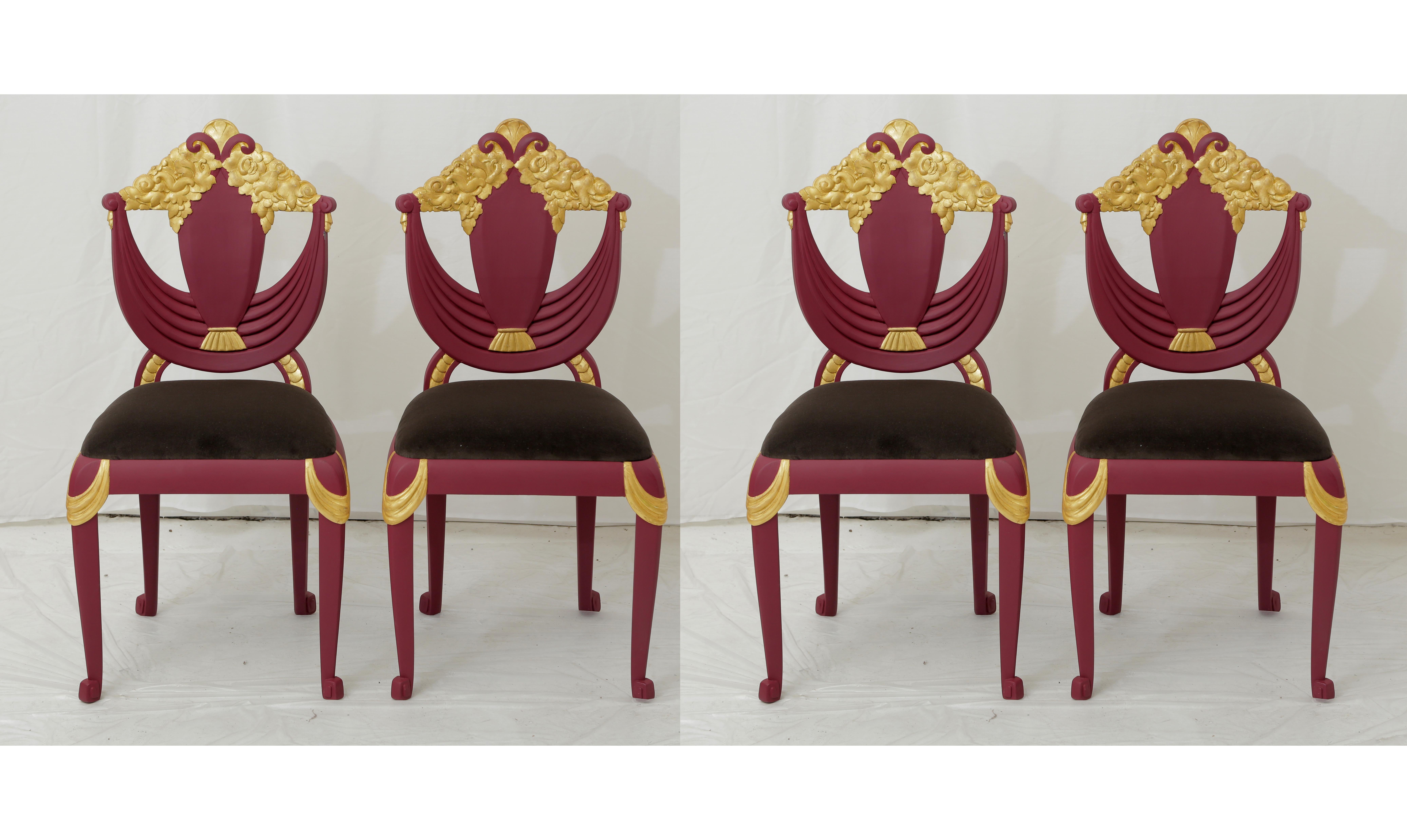 Set of four Art Deco (Transitional from Art Nouveau) chairs attributed to Sue & Mare made of beechwood and painted in a Burgundy color with gold leaf gilded carved ornaments on the hand carved parts. Reupholstered with a brand new dark grey velvet