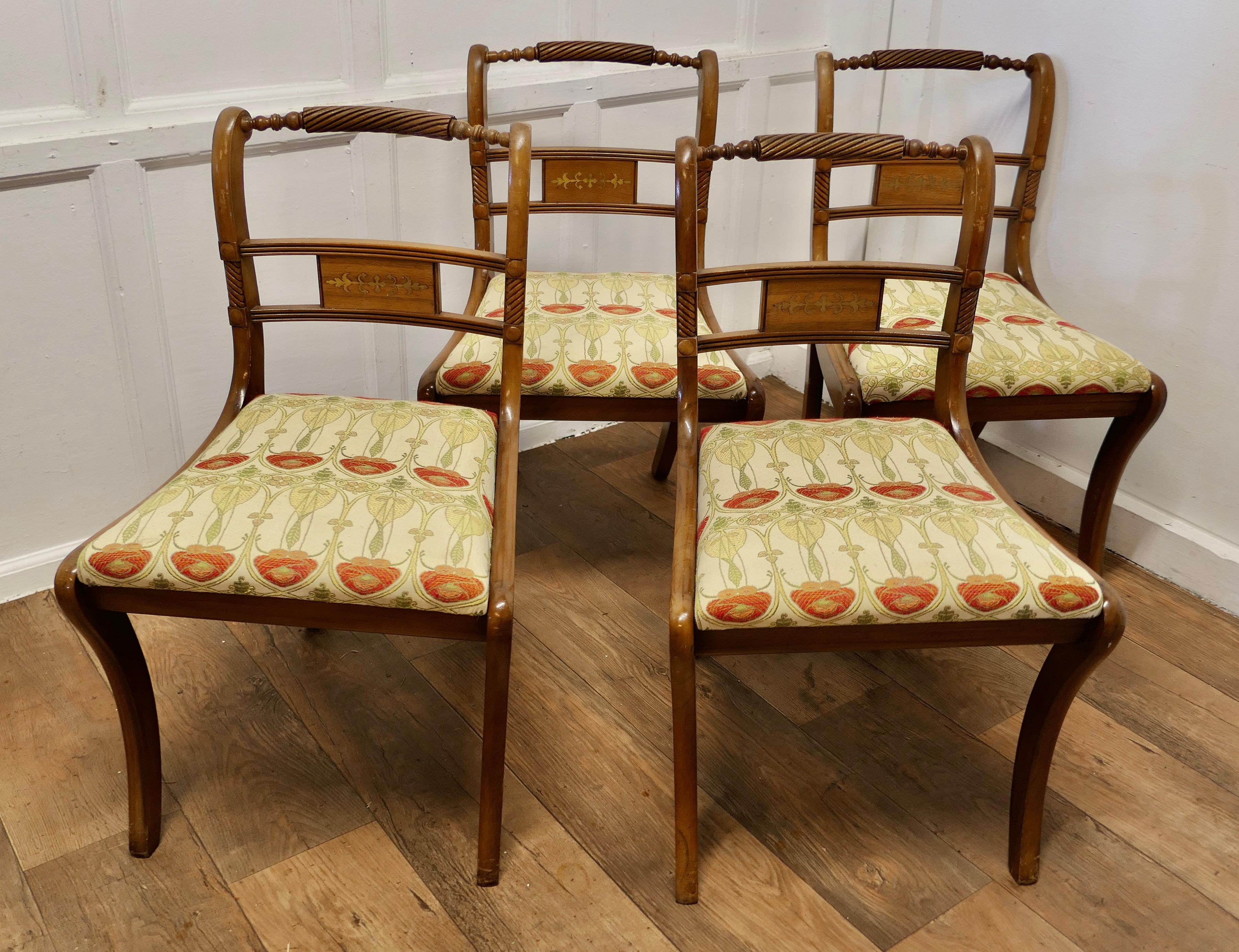 Set of 4 Art Nouveau Walnut Dining Chairs

An unusual set of chairs, the top rail of the chair backs are curved and twisted, the back panel is inlaid with brass

The Chairs are Good and Stylish they have sabre legs and trafalgar style seats and have