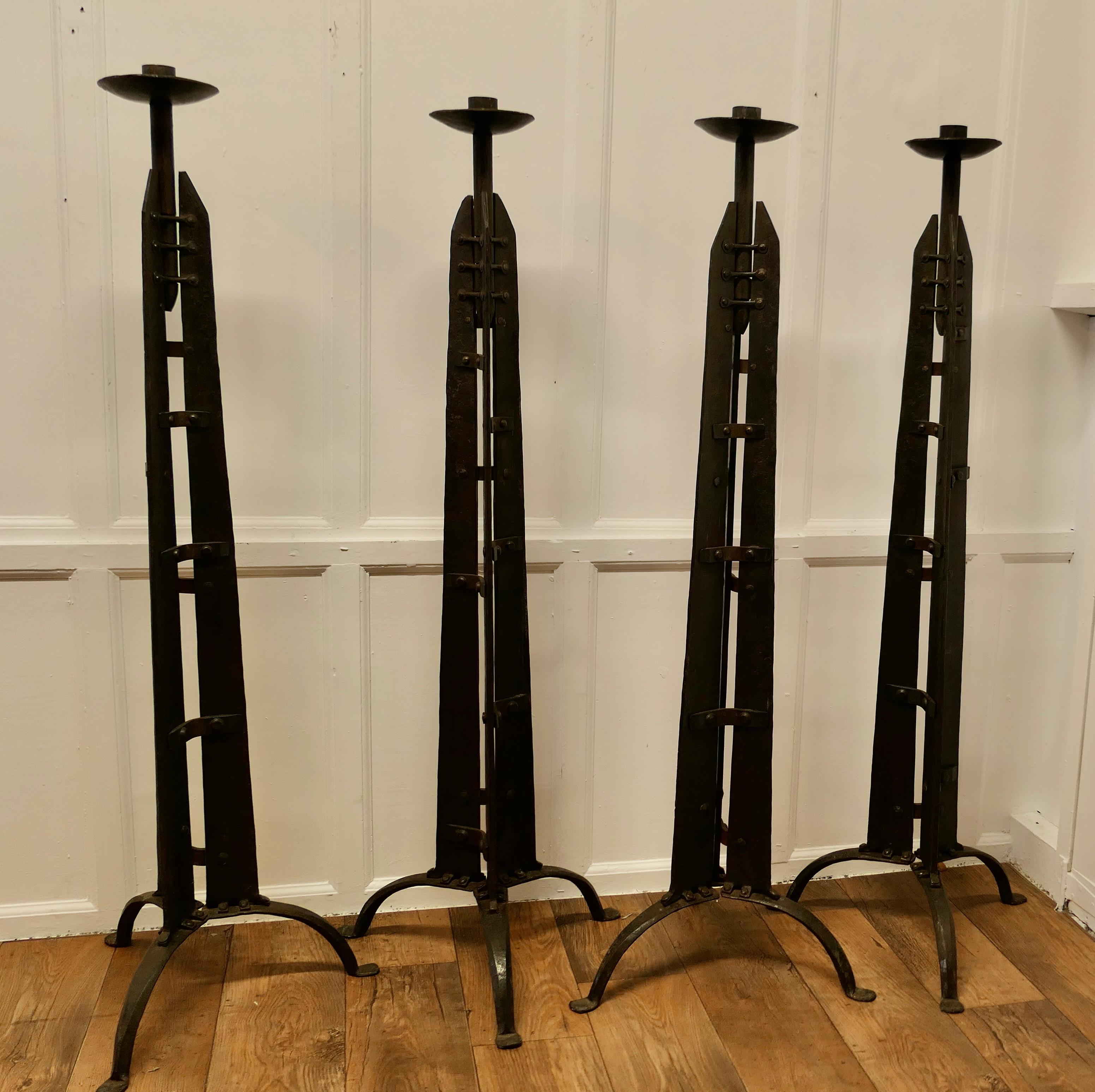 Set of 4 Arts and Crafts Gothic Candle Stands 

This is a Set of 4 Superbly Hand Forged Iron 5ft Floor Standing Cathedral Candle Sticks

These wonderful pieces were designed by Harrison Sutton for Plymouth Cathedral in 1994, there were other pieces