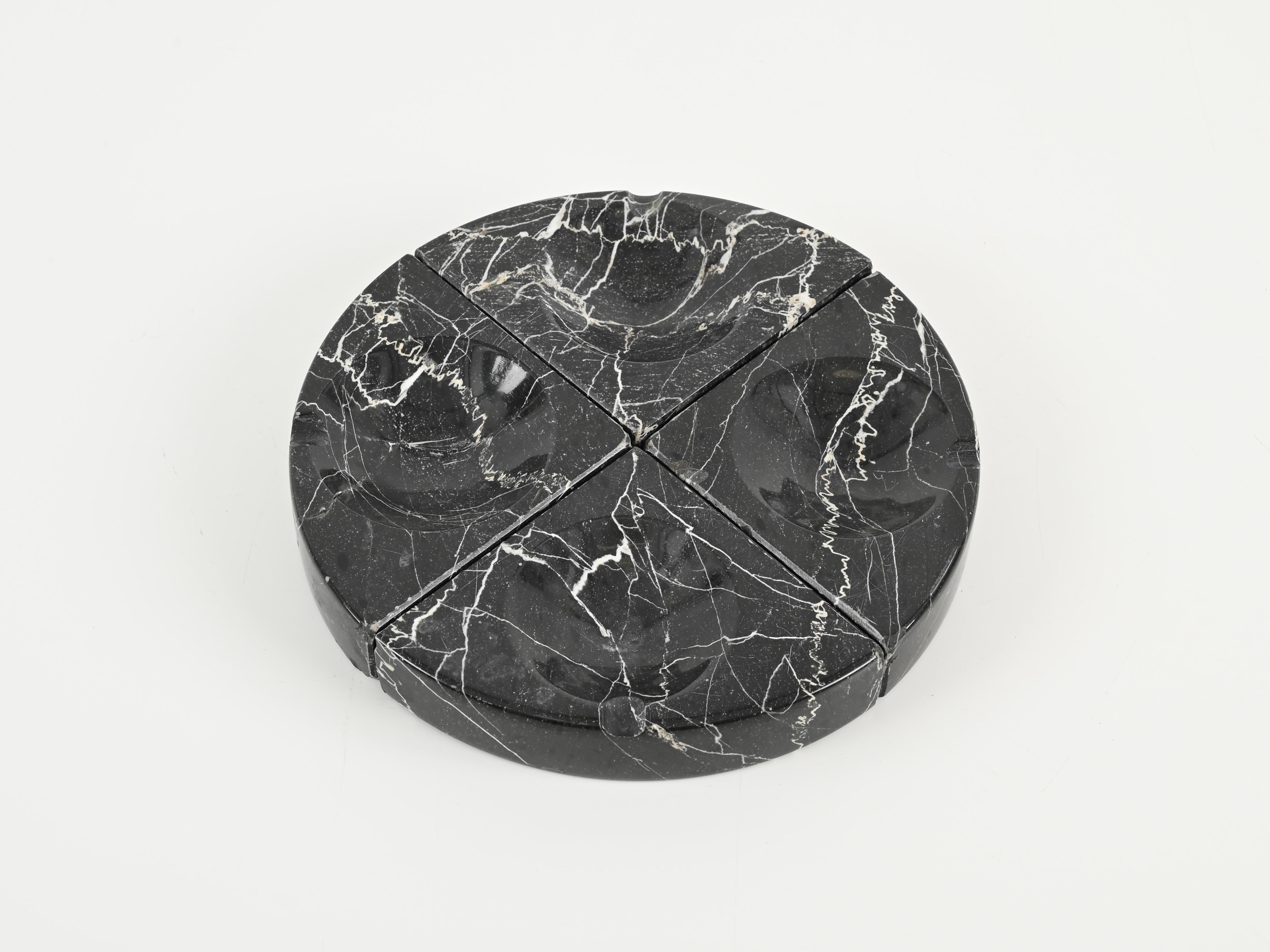 Wonderful set of 4 triangular modular ashtrays in Belgian black marble designed by Angelo Mangiarotti in and produced in Italy during the 1970s.

This stylish modular ashtray is made out of 4 triangular ashtrays that when placed one next to the
