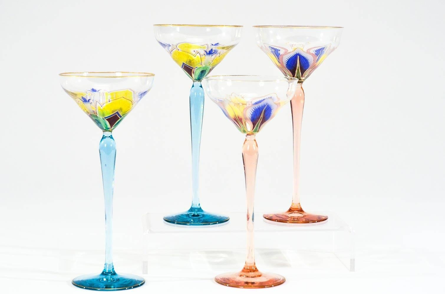For the collector, this is a set 4 tall hand blown crystal goblets with hand painted transparent enamel floral decoration in the Art Nouveau style. Each is uniquely decorated with flowers with a beautiful gold trim. Made by one of the great Bohemian