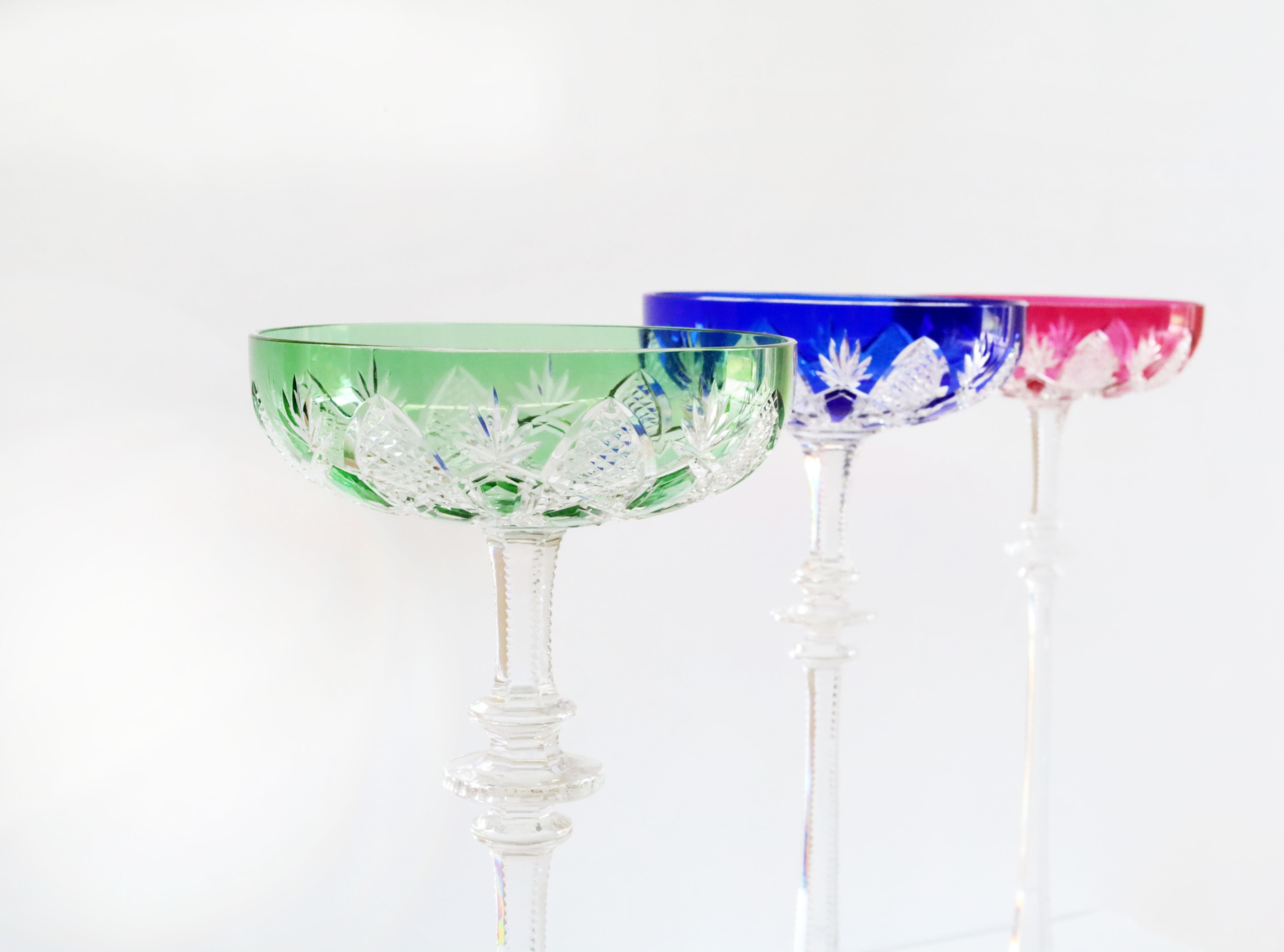 Created for Tsar Nicholas II, this clear crystal bowl - overlaid in coloured crystal with a high stem, a scalloped base, and diamond and palm leaf decorations - is spectacular. This exceptional set won over many aristocrats in the Imperial Court and