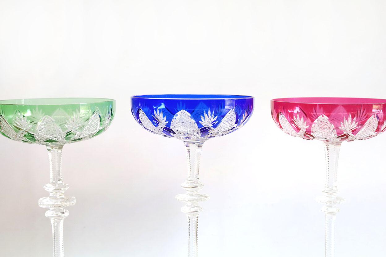 Created for Tsar Nicholas II, this clear crystal bowl - overlaid in coloured crystal with a high stem, a scalloped base, and diamond and palm leaf decorations - is spectacular. This exceptional set won over many aristocrats in the Imperial Court and