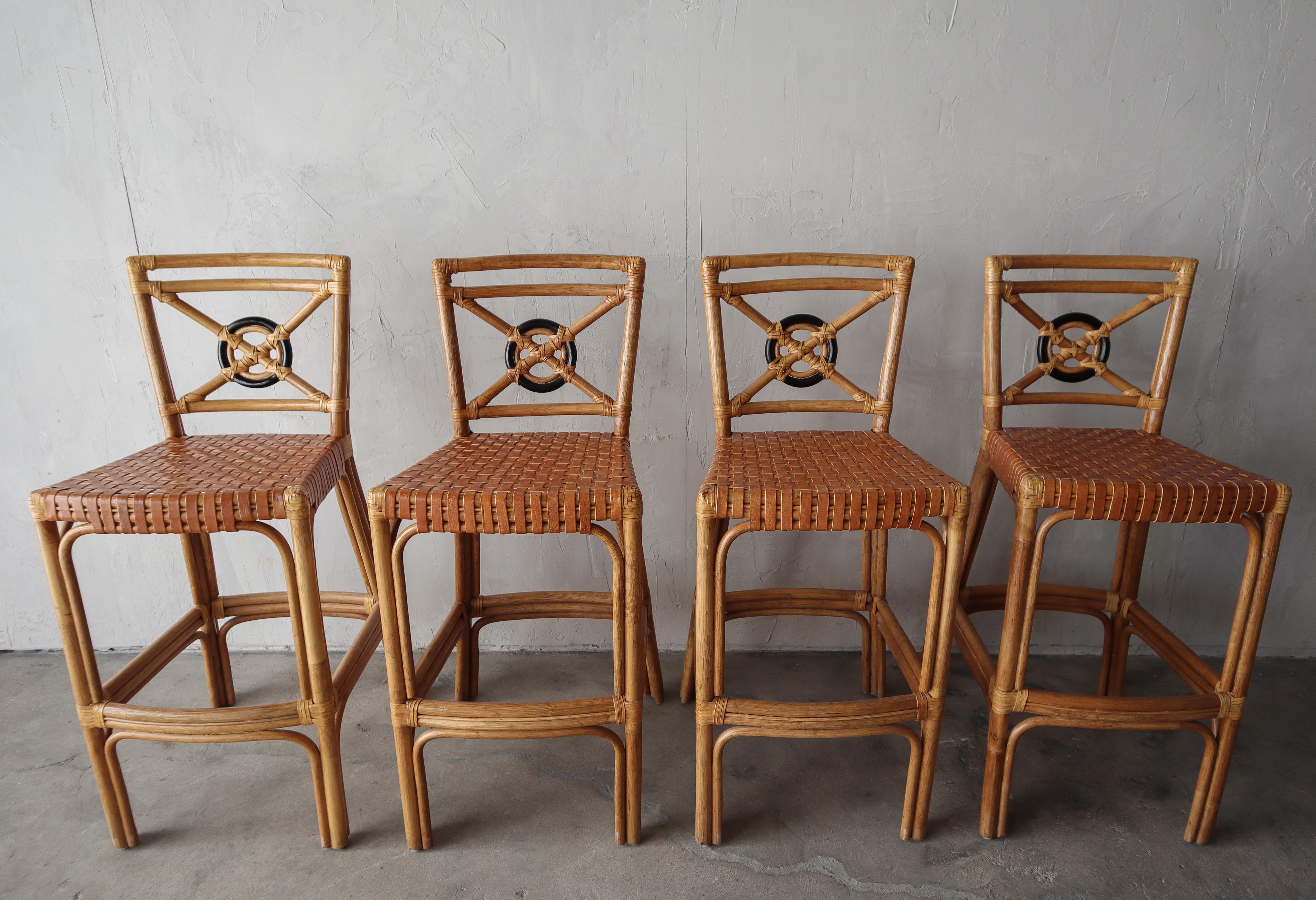 Stunning example of vintage bamboo. This gorgeous set of bamboo barstools with woven leather seats and hand tied leather details is the perfect. They will mesh well with many styles of decor.

The set of 4 is in excellent condition with little to