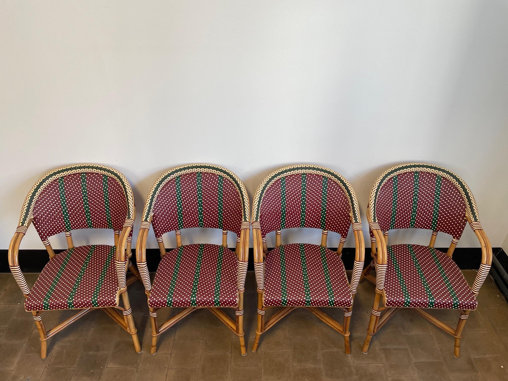 4 no light rattan / bamboo arm chairs hand crafted by Maison Louis Drucker Paris:
inversé weaving pattern in Colors  Ruby Red , Bottle Green and White.
Robust, light, durable, stackable furniture to bring in during the off-season.
Material Weaving: