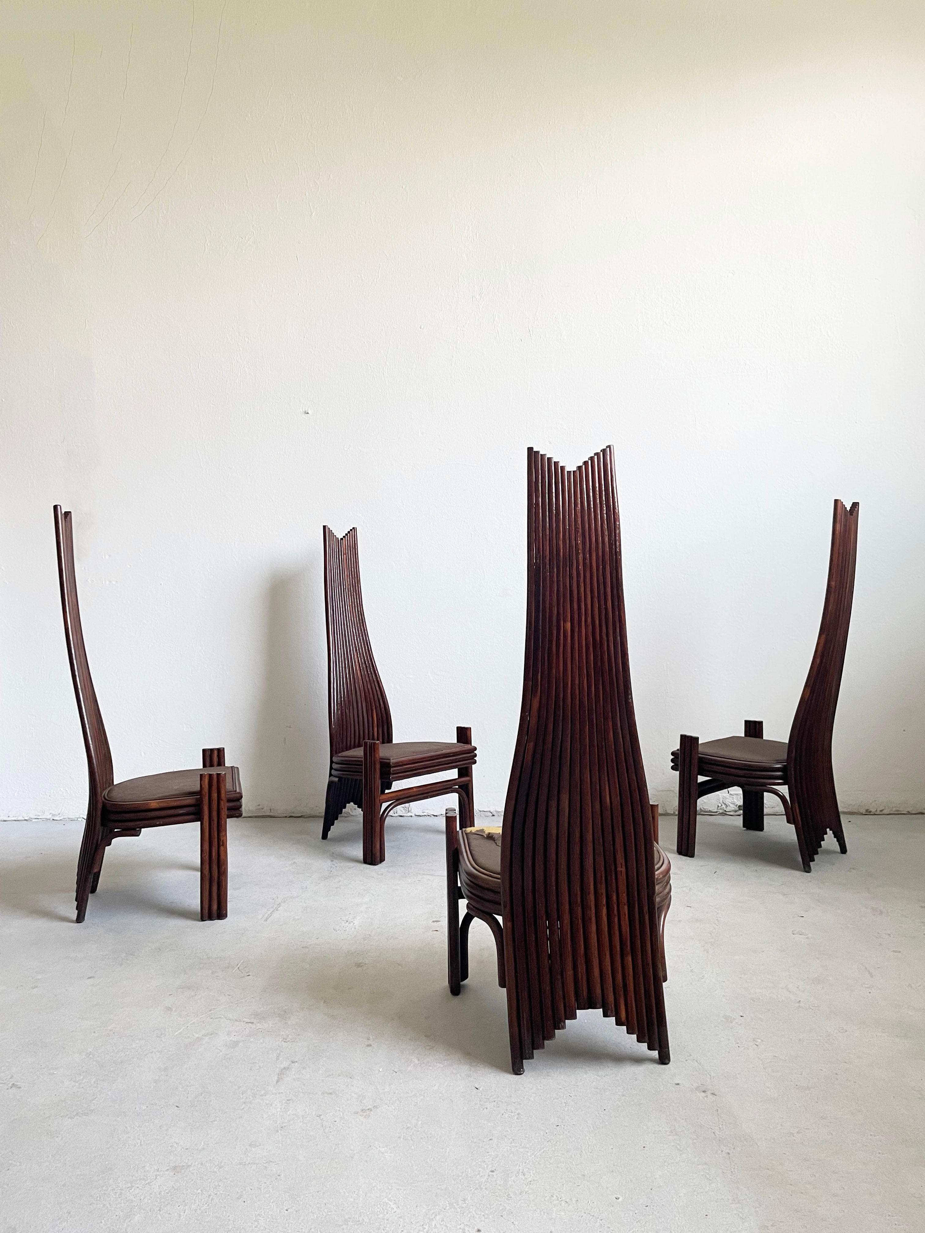 Set of four extravagant dining chairs designed and produced by Mcguire in the USA in the 1980s. 

This design is often attributed to Danny Ho Fong. 

The chairs are constructed of dark brown stained bamboo, and have a very high curved back.

The