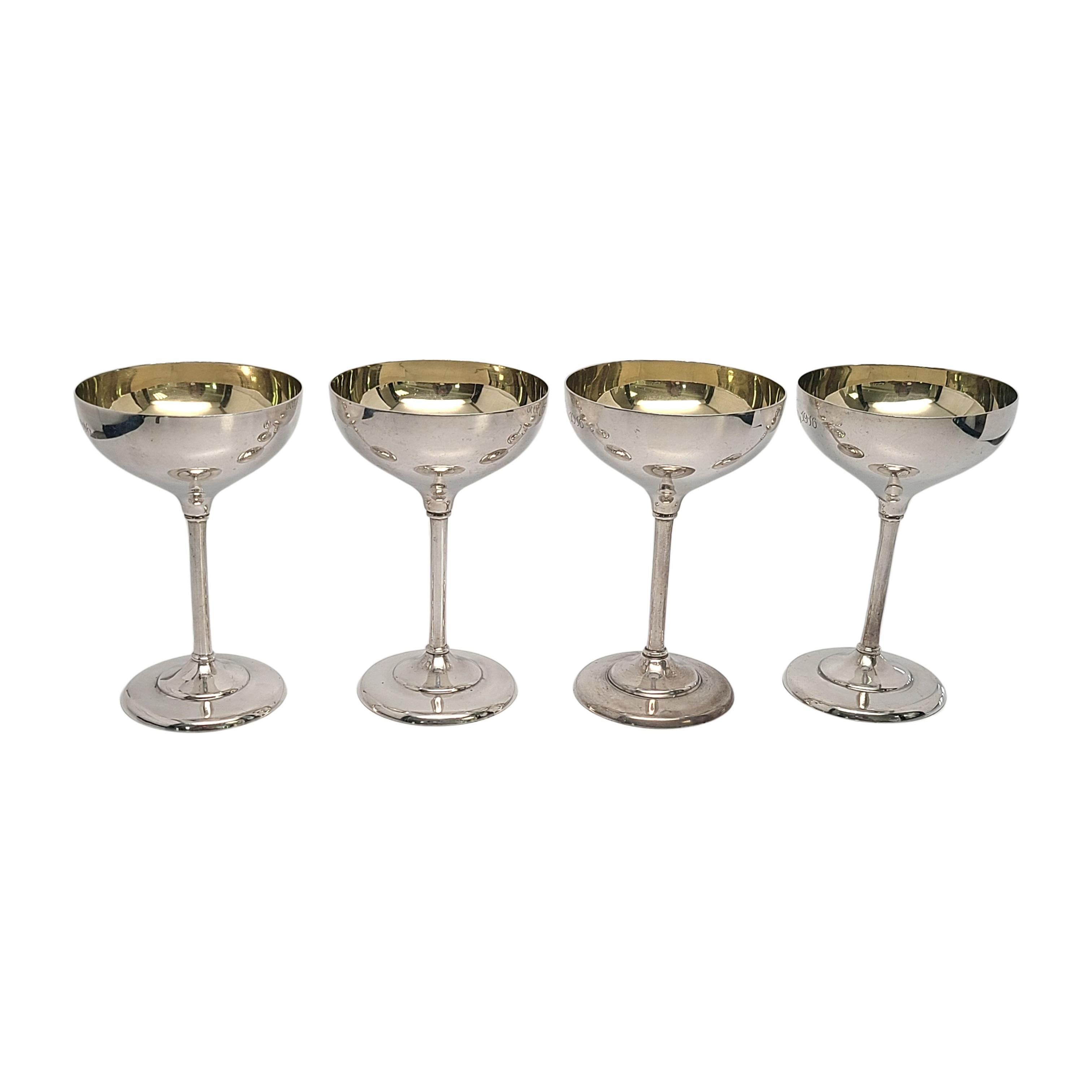 Set of 4 sterling silver champagne or cocktail goblets by Barbour Silver Co for Bailey, Banks & Biddle.

Engraving appears to be 1891 T&J 1916

A simple and classic child polished design with gold wash interior. Long stem and shallow cup. Engraving