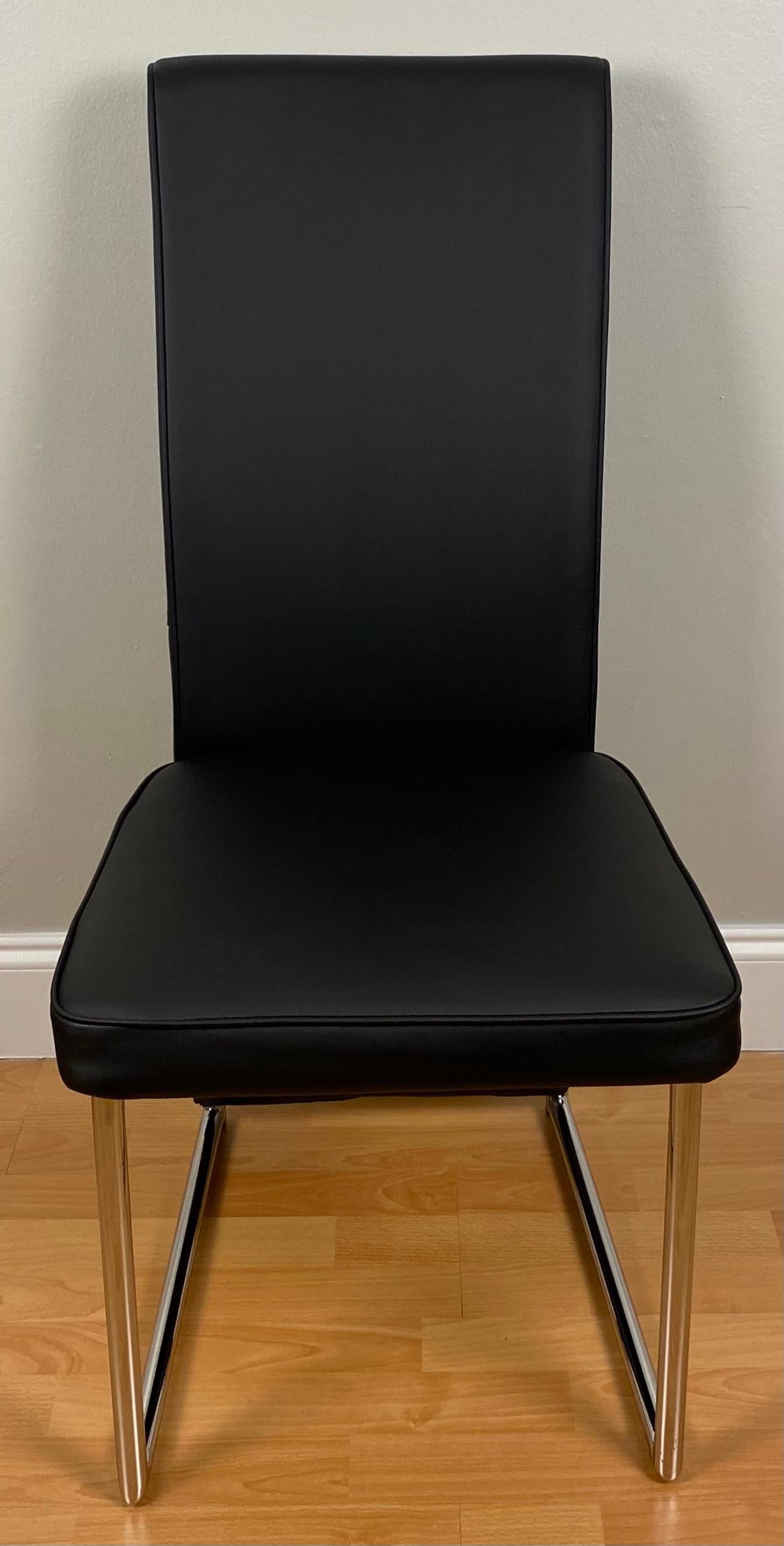 Good quality set of four comfortable and sturdy Baughman style dining chairs upholstered with faux black leather.

The well crafted chrome frames would look great in a contemporary setting. Constructed well enough to use daily or store for extra