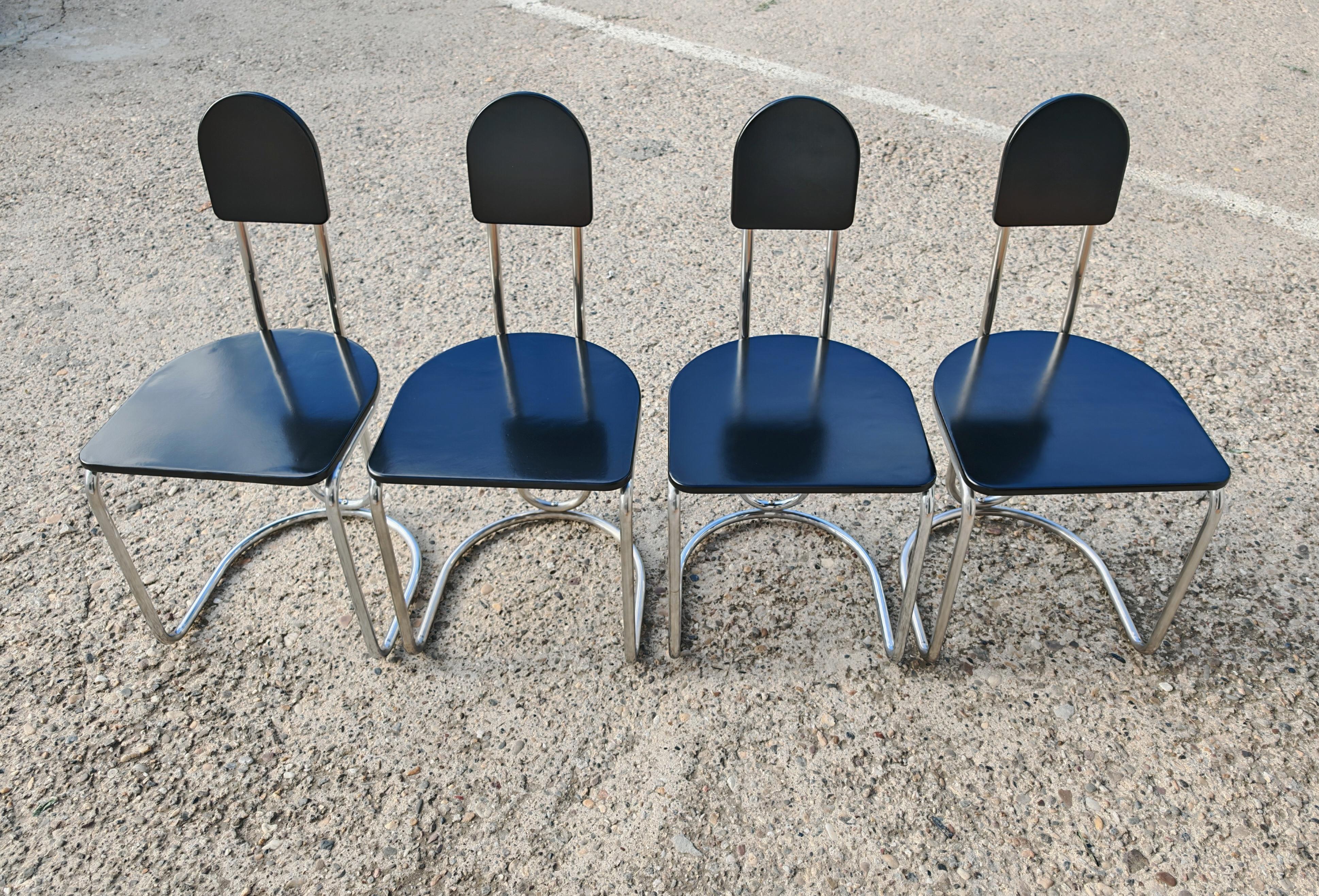 In this listing you will find a set of 4 Bauhaus dining chairs. They feature sleek constructions done in chrome plated steel and black lacquer wood seats and backrests. The chairs are done in style of Eileen Gray and fit perfectly with her Jean