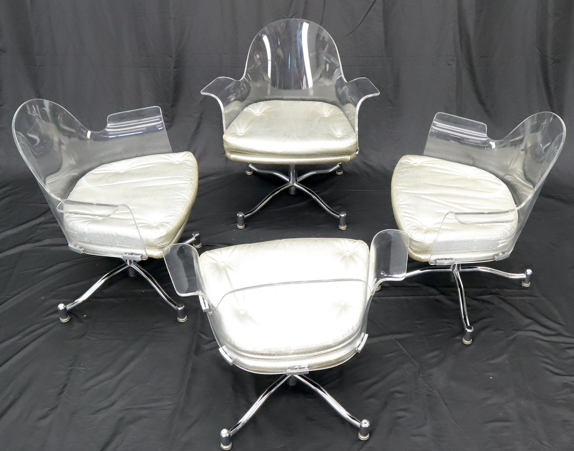 Mid-Century Modern set of 4 bent Lucite dining chairs. Silver patten leather upholstery. Chrome X-bases.