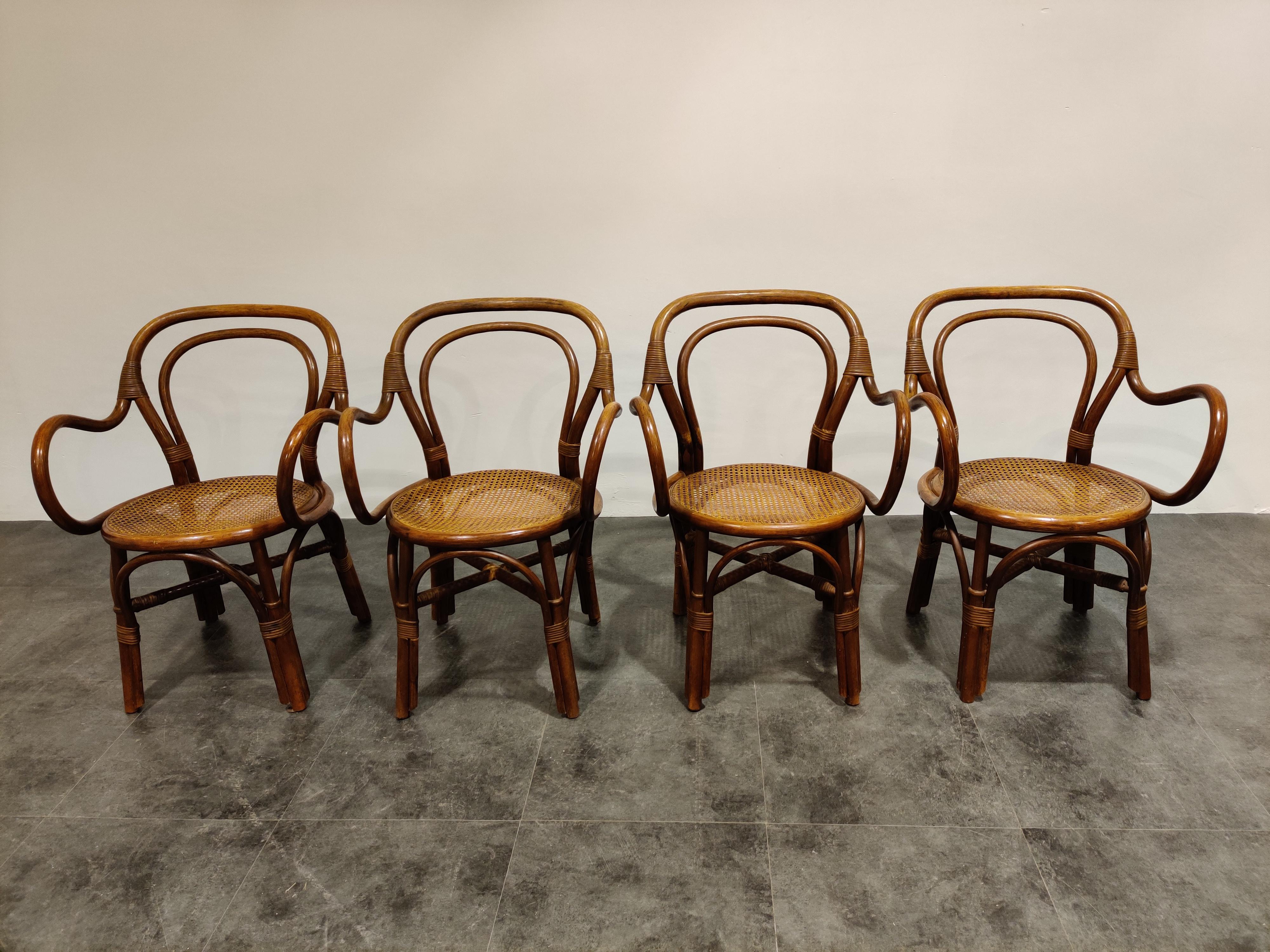 Set of 4 unique bentwooden dining chairs with woven rattan seats.

Beautiful elegant design and seat quite well.

1960s

Dimensions: 
Height 85cm/33.46