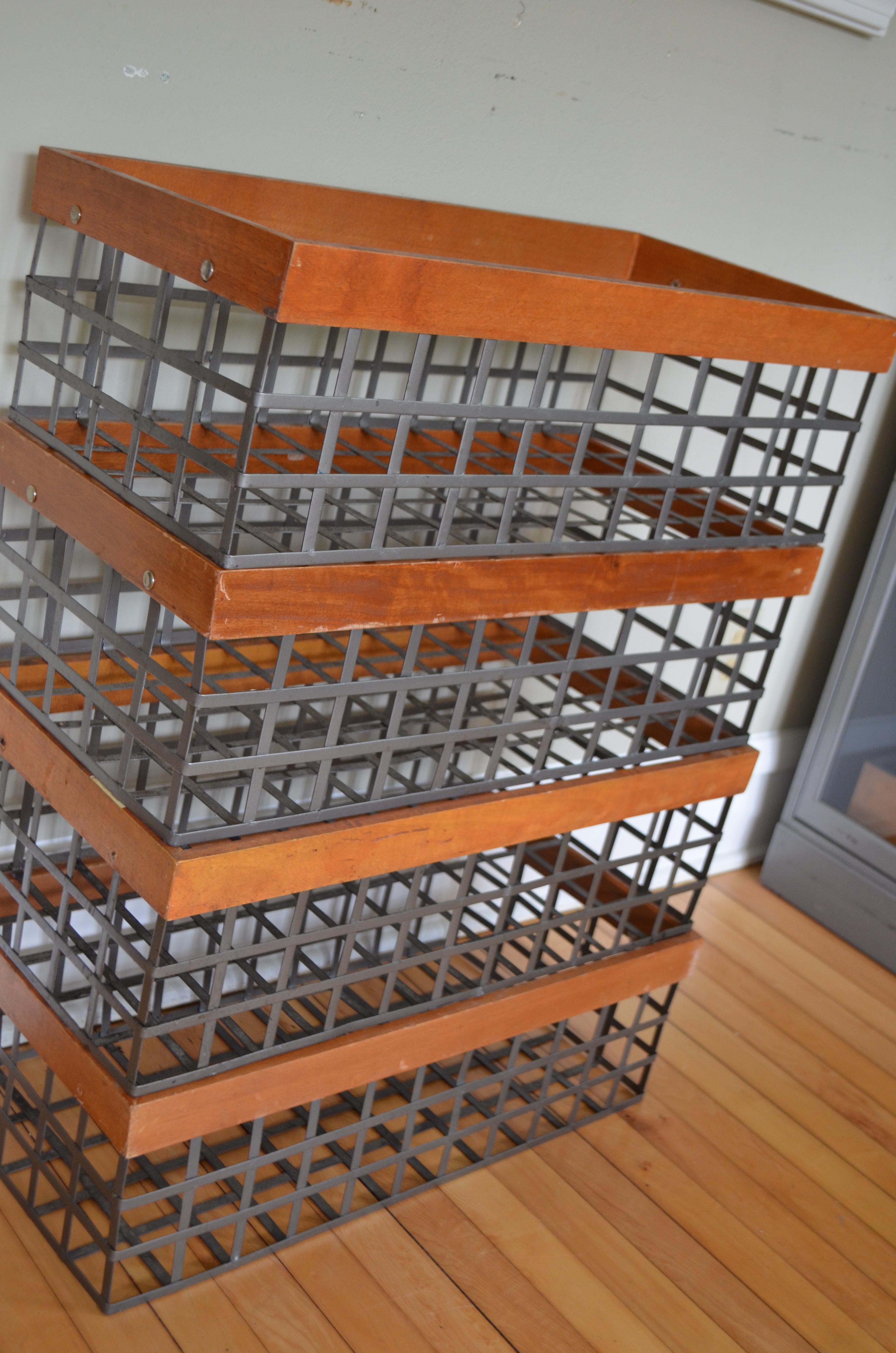 Classic organizational storage bins / baskets, these were originally used to hold and display produce in the local grocery store of yesteryear. Steel strapping with wood trim. Put them to use to store your towels, boots, toys, wine, books, plants or