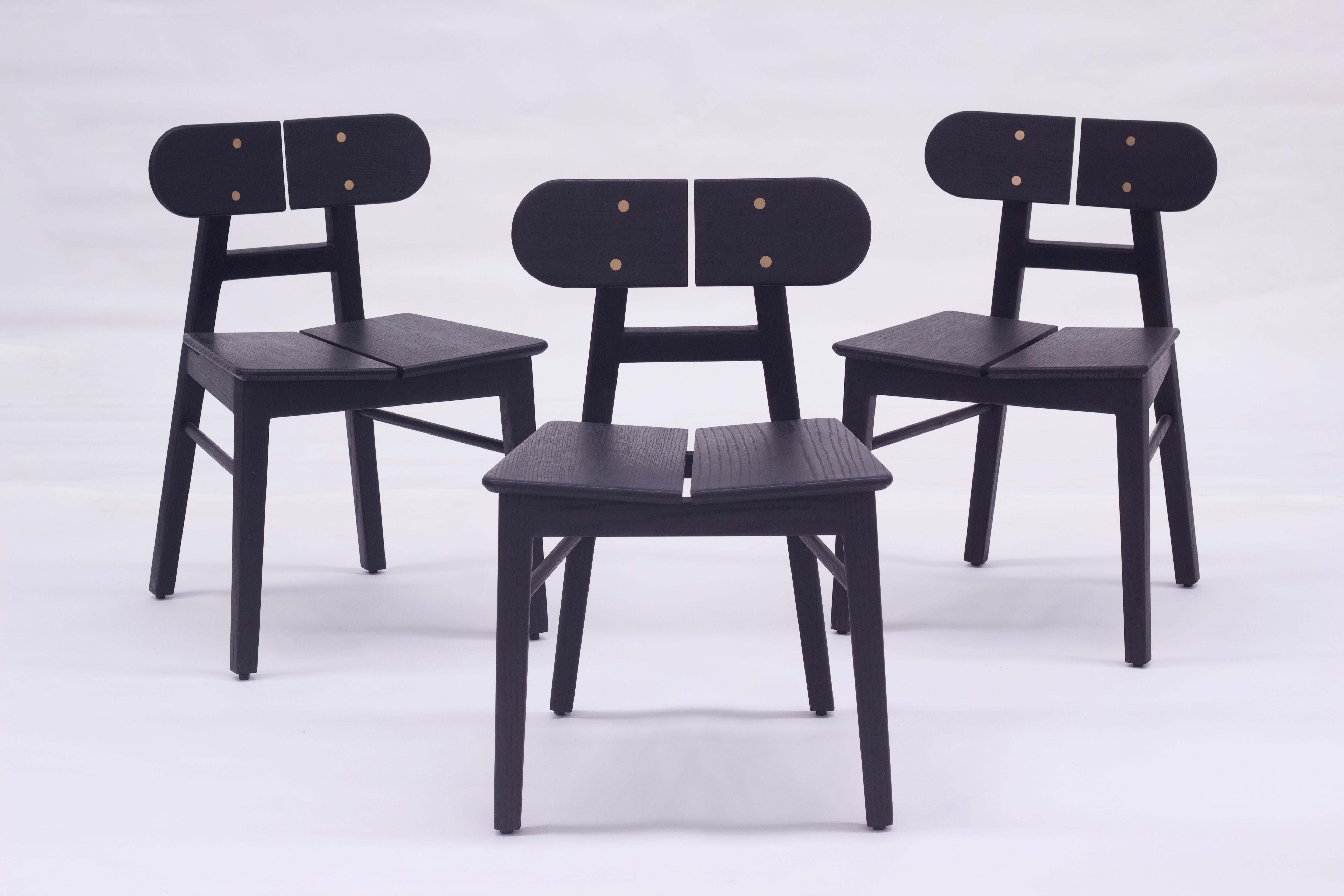 A set of 4 black solid Oak wood chairs crafted for comfort and a timeless aesthetic, the BUTTERFLY chair design is inspired by the beauty of a butterfly and developed through a design philosophy of conscious minimalism. The design makes a
