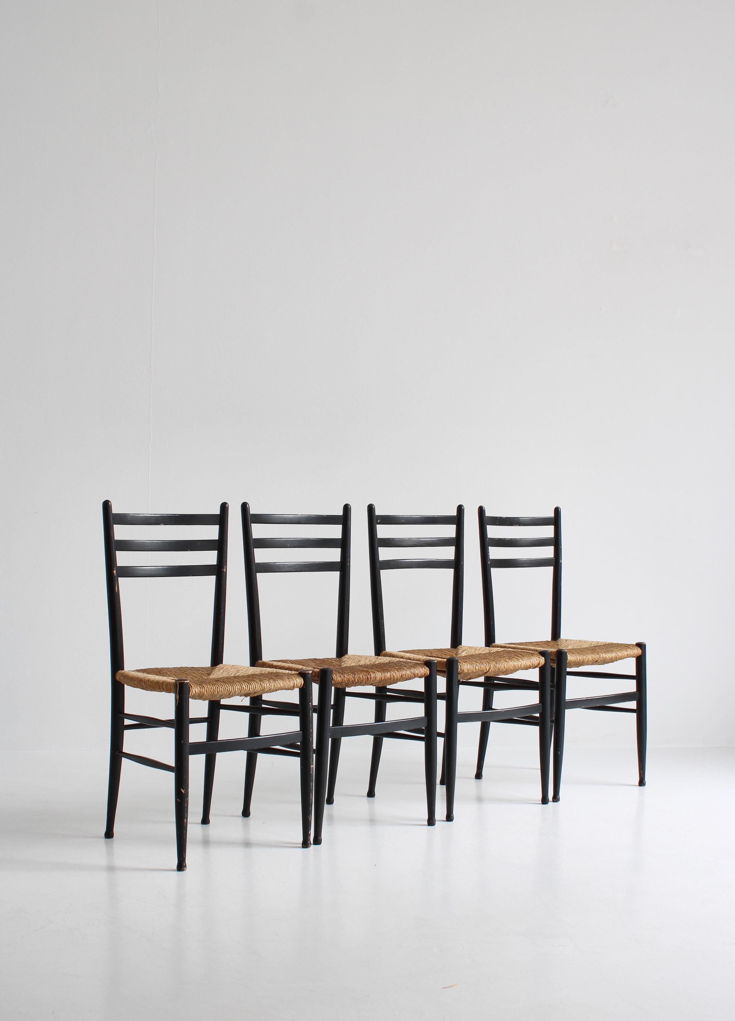 Wonderful set of 4 original vintage dining chairs made in Italy in the 1960s by Gessef. The chairs are in fair unrestored condition and still retains the original black lacquer and the rustique seats in thick hand woven seagrass. The style is