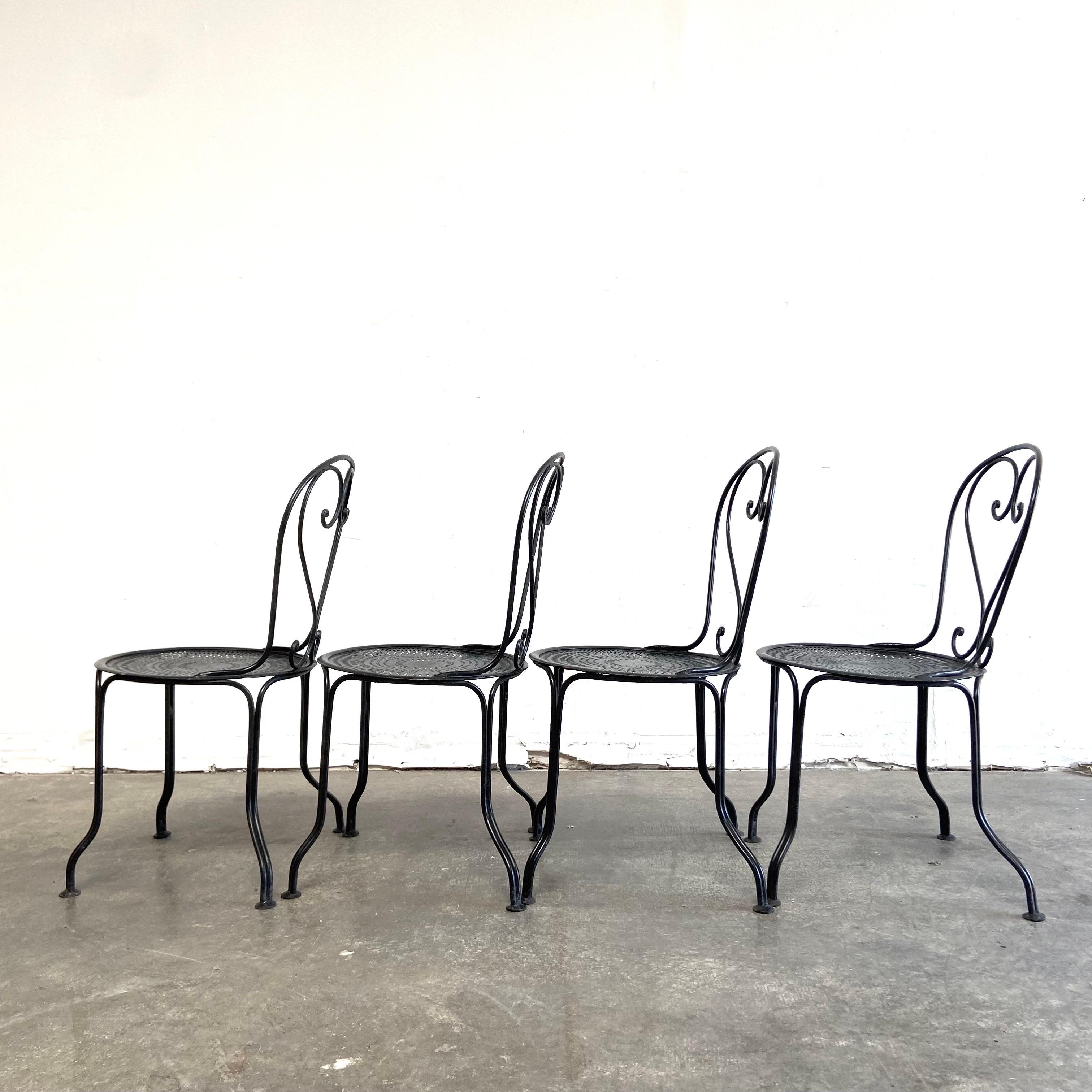 Set of 4 outdoor French iron dining chairs in black.
Overall each chair is in good condition, very solid and sturdy can be used for everyday inside or outside.
Origin: France
Size;
18”W x 18”D x 31”H 
Seat height: 16” 
Seat: 16”diameter.