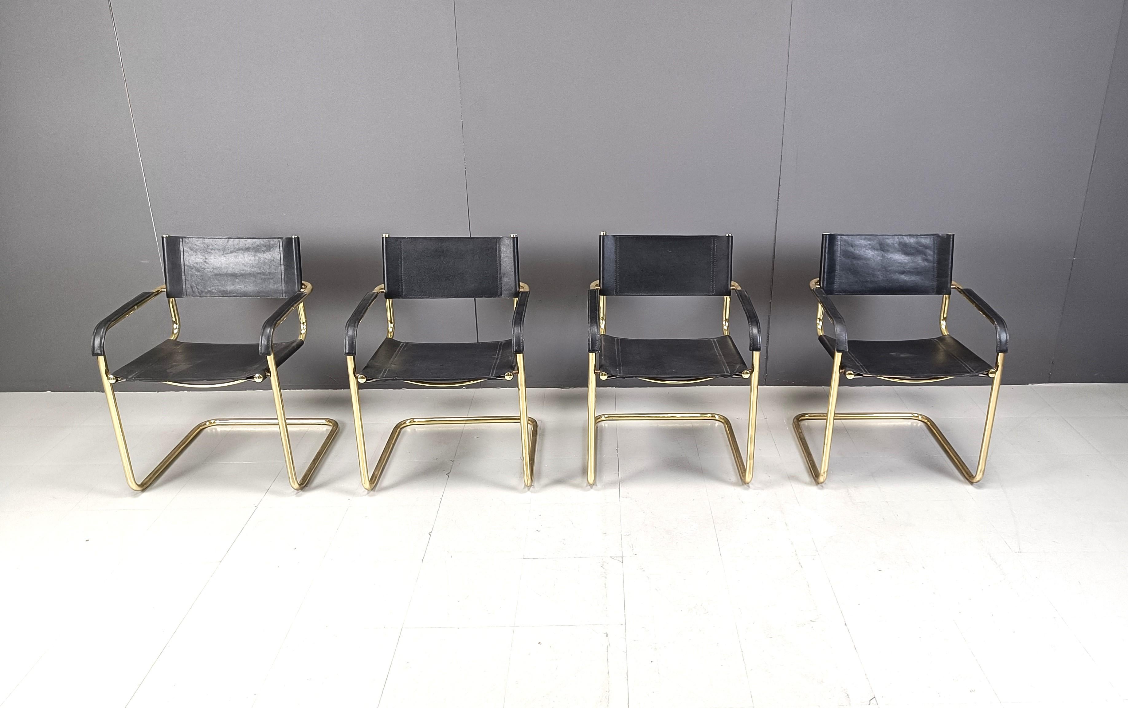 Cantilever dining chairs inspired by Marcel Breuer Bauhaus design featuring patinated brass frames and black leather.

the armrests also have leather padding.

Beautiful, timeless design.

1970s - Italy

Good condition, strong leather, light patina