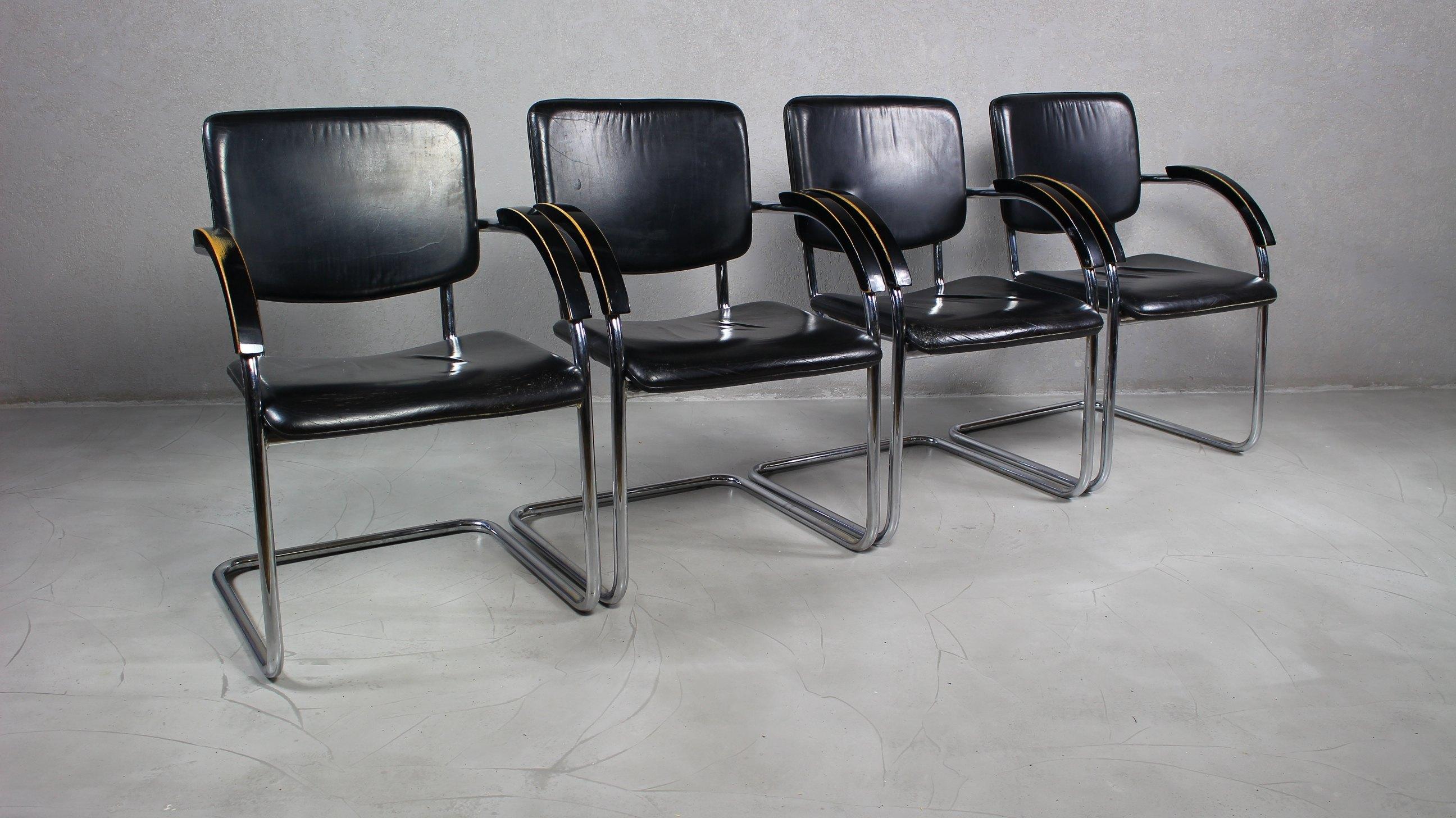 Tubular steel Bauhaus armchairs Circa 1940s. 
Tubular steel frames with faux leather.
Varnished wooden armrests.
Stable structure, the leather has scratches and abrasions.