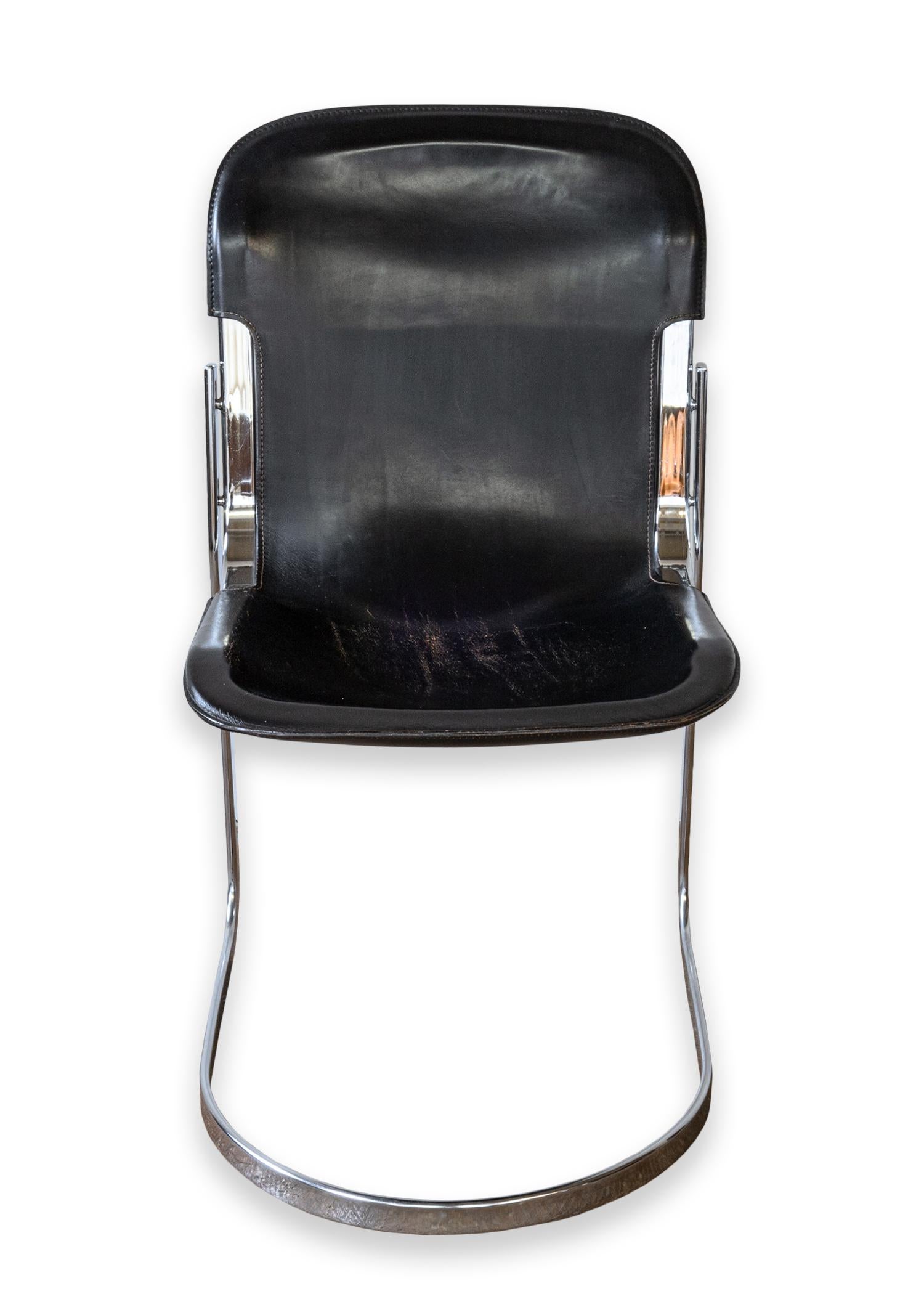 A set of 4 dining or accent chairs designed by Willy Rizzo for Cidue. A stunning set of vintage Italian designed cantilever chairs, iconic and minimal. These chairs feature a chrome cantilever frame, and a rich black leather seat. These chairs are
