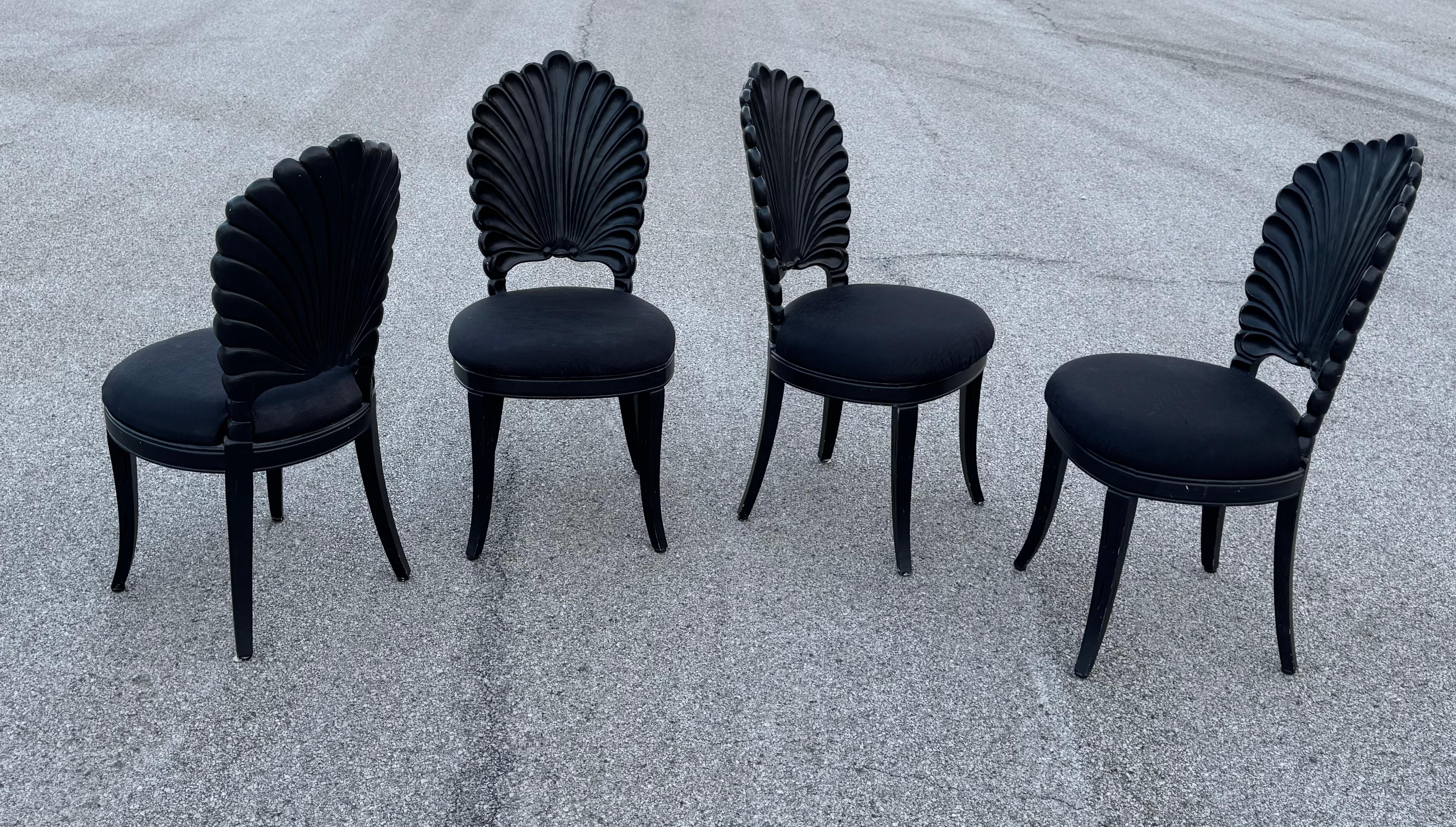 Set of 4 Grotto style scalloped wood shell back dining side chairs in lacquered in black. Each wooden chair features a Venetian grotto style scalloped shell back, with padded black upholstered seat, on four curved legs. 