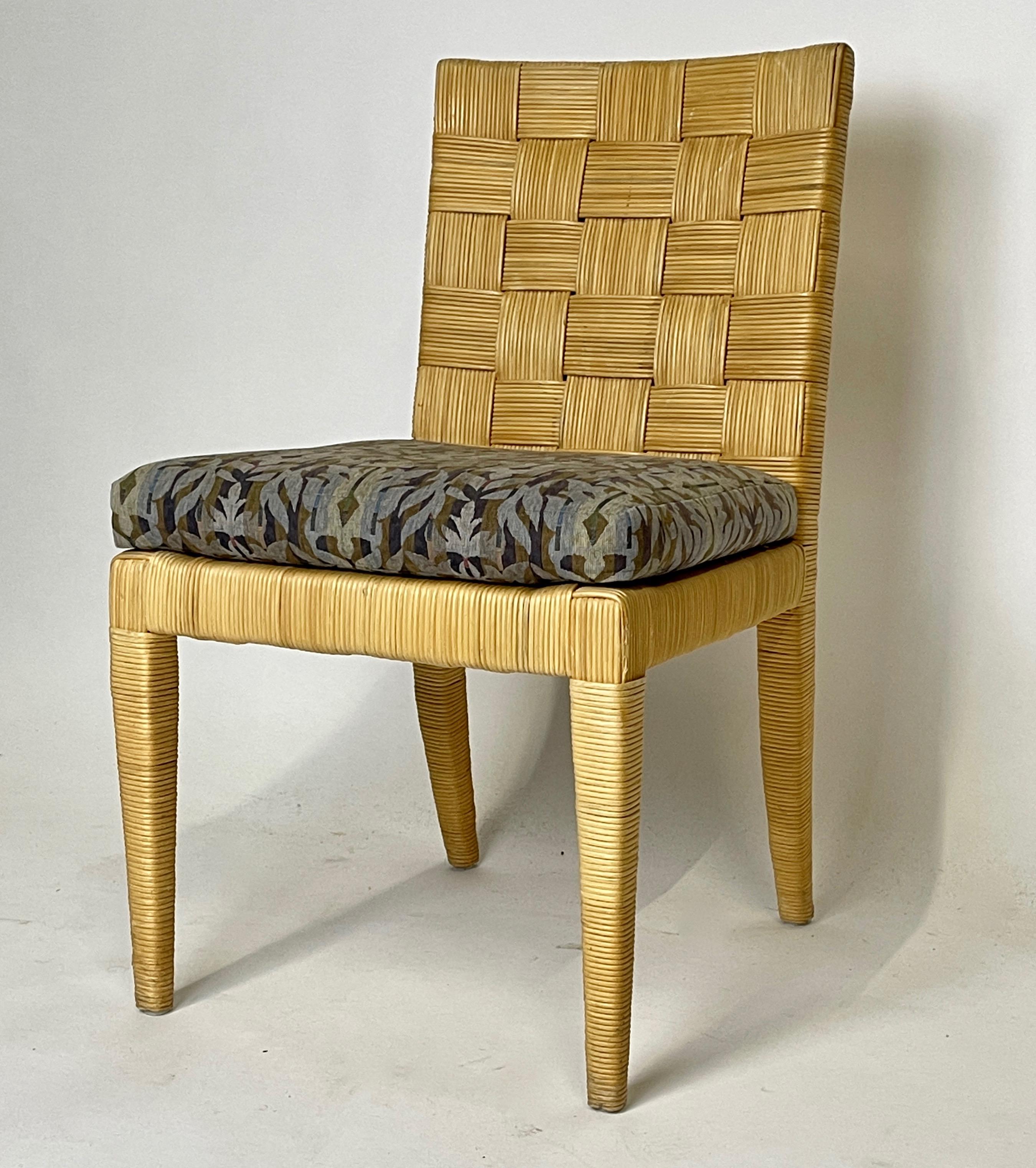 A set of four Donghia Block Island dining chairs designed by John Hutton. The frames are a handwoven rattan in a checkered pattern. Mr. Hutton was the firm design director from 1978-1998 and was responsible for many of the iconic designs from