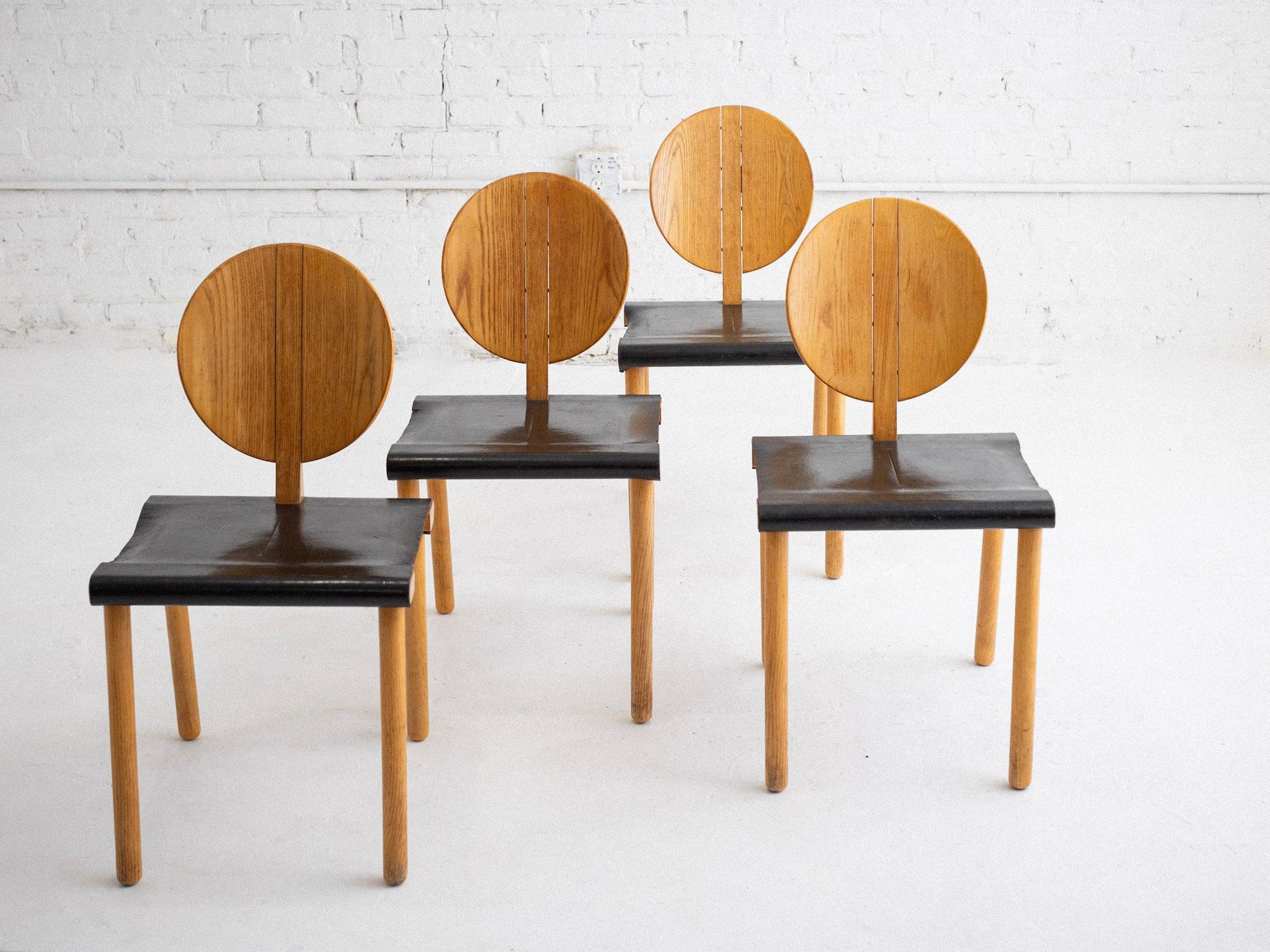 A set of four “Fiona” chairs by Gigi Sabadin for Crassevig. Plywood frames with saddle leather seats. Graphic postmodern silhouette. Sourced in Rome, Italy.

Gigi Sabadin (1930-2016) was an Italian designer celebrated for his innovative and refined