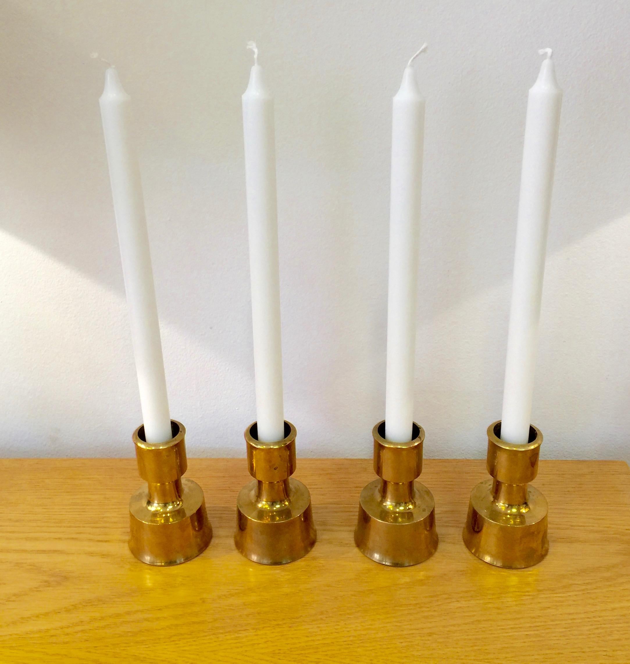 Set of 4 solid brass candlesticks by Jens H. Quistgaard and manufactured by Dansk design. Provenance: From the home of Kurt Östervig.