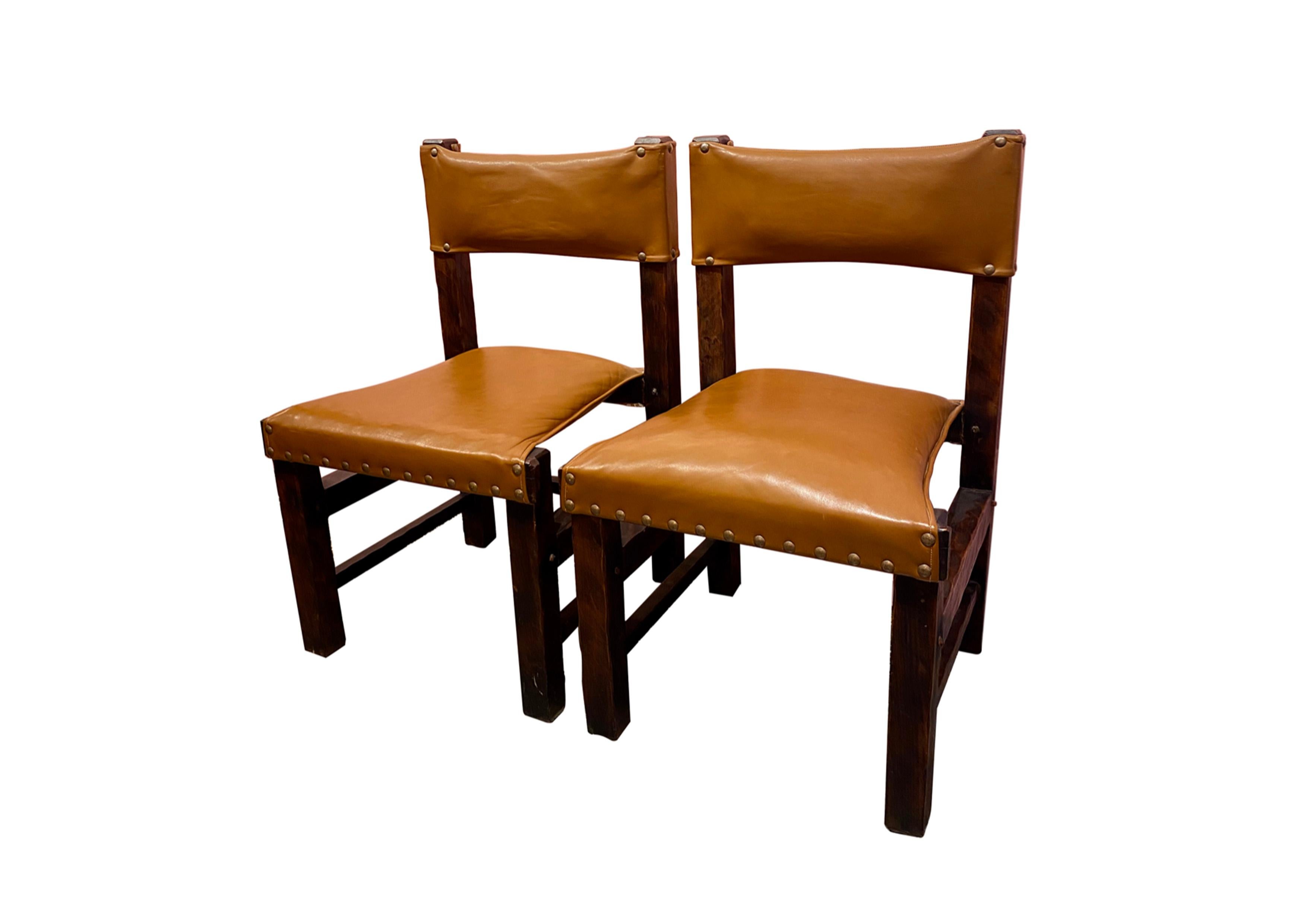 Set of six Brazilian chairs from the 60s. 
Solid wood structure, back and seat in cognac leather with studs offering original seat and back detailing.

Wear consistent with age and use. Minor defects.