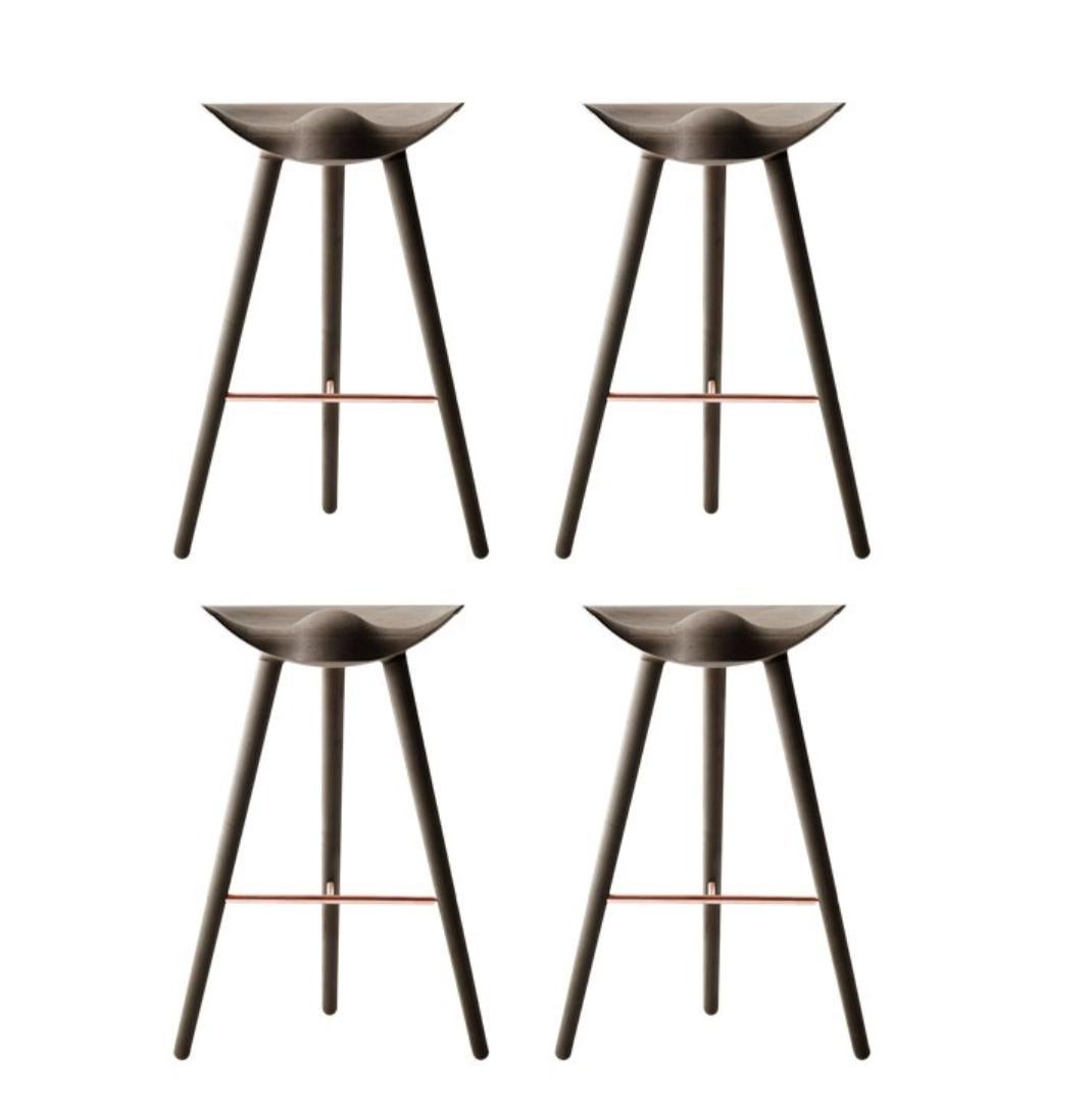 Set of 4 ML 42 brown oak and copper bar stools by Lassen
Dimensions: H 77 x W 36 x L 55.5 cm.
Materials: oak, brass.

In 1942 Mogens Lassen designed the stool ML42 as a piece for a furniture exhibition held at the Danish Museum of Decorative Art. He