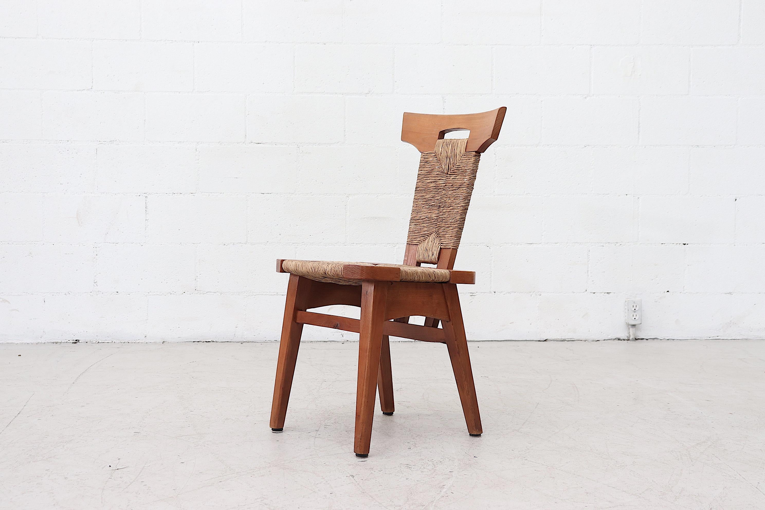 Set of 4 Pierre Chapo style Brutalist rush and wood dining chairs with handle cut-out in backrest. Cool Wrapped Rush design. In original condition with wear consistent with their age and usage. Set price.