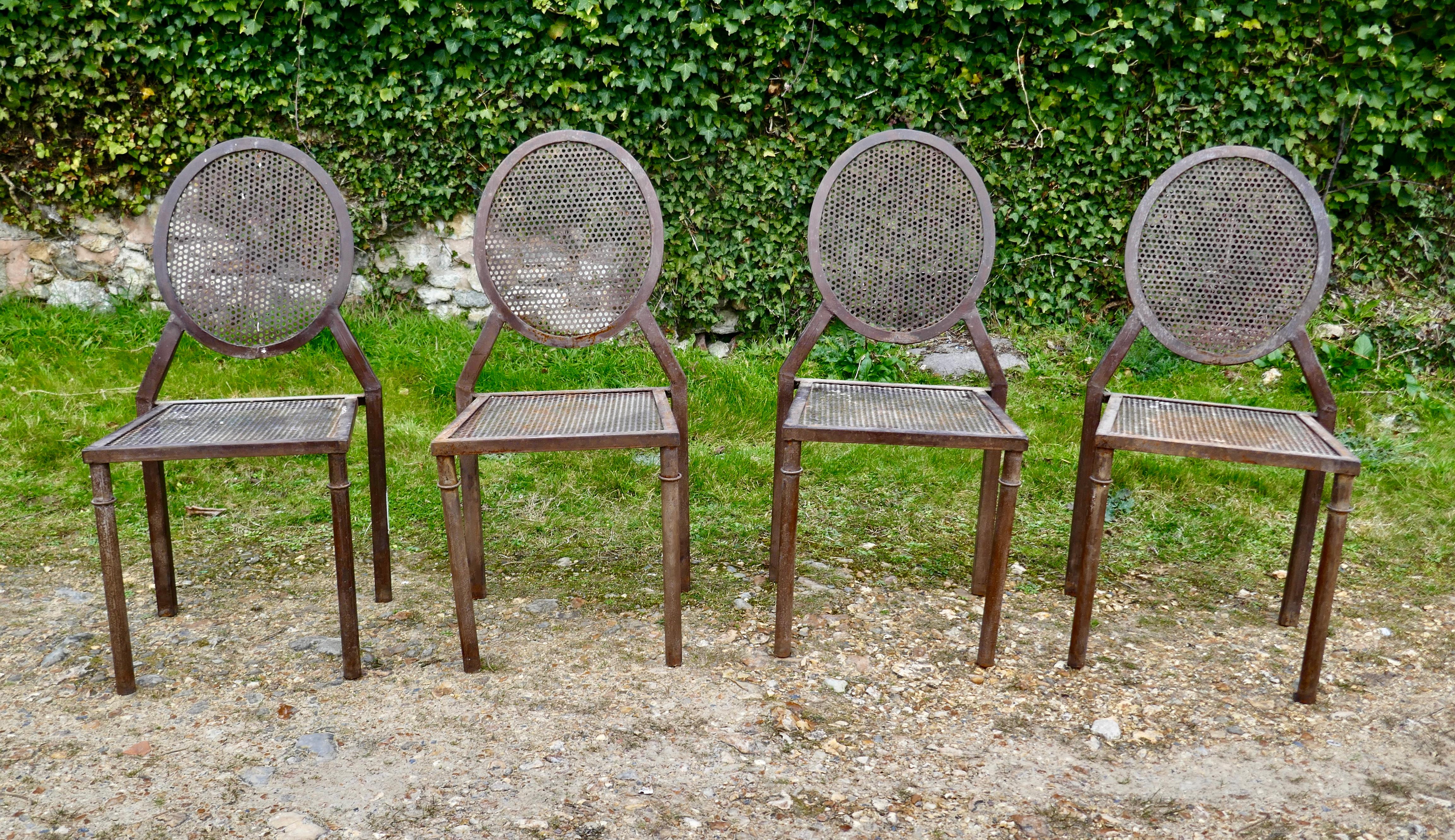 Set of 4 Brutalist iron stacking dining chairs

Great pieces, a set of good heavy iron chairs which have square seats and round backs with inset heavy mesh
These stylish chairs would work as well in a garden or a modernist setting indoors with