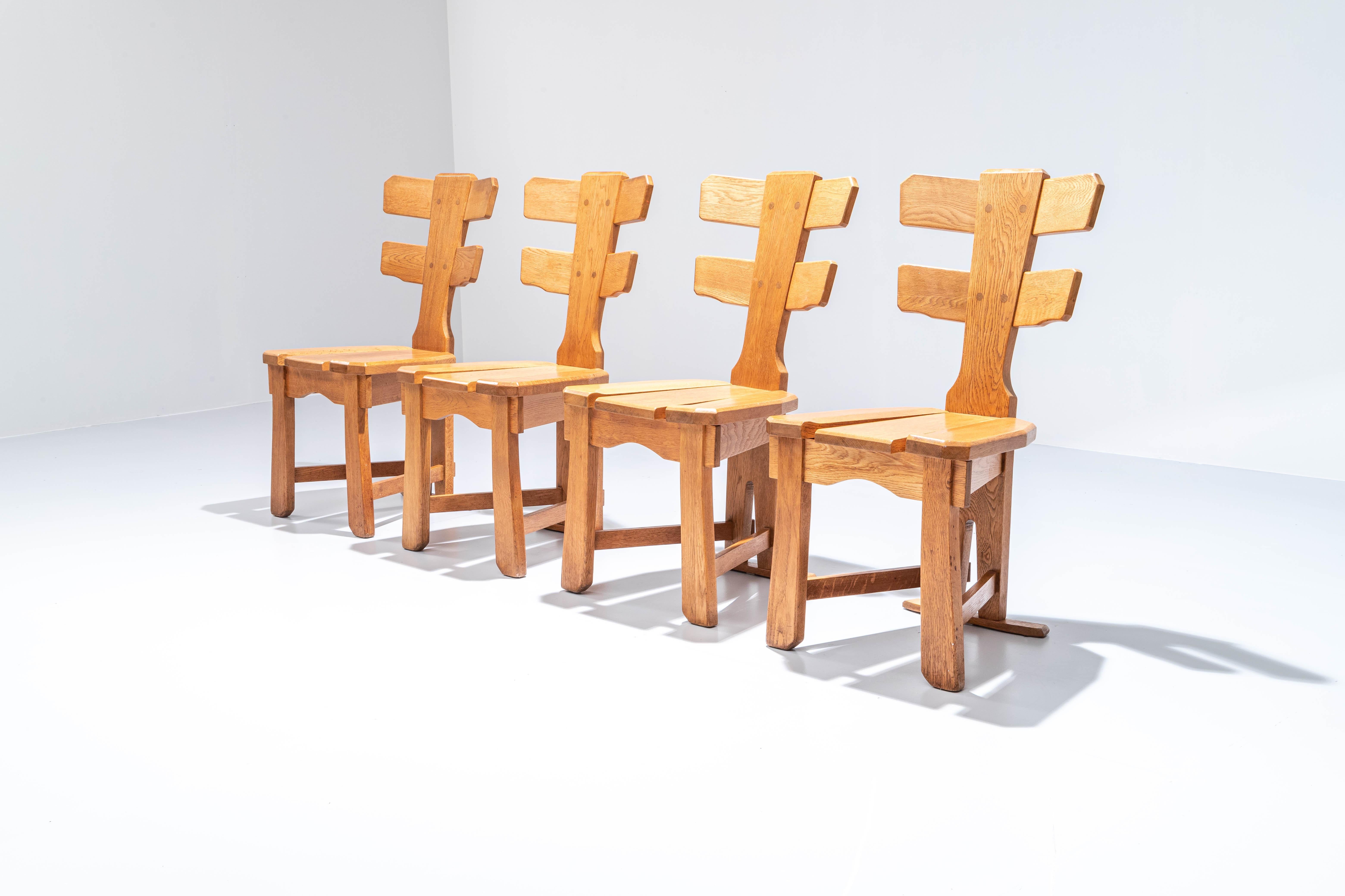 Set of 4 blonde and fresh sculptural dining chairs. Strong, robust, and heavy: these chairs will remain on earth for the next few century's. A nice wale carcass like construction in the backrest make sure these chairs will stand out in your