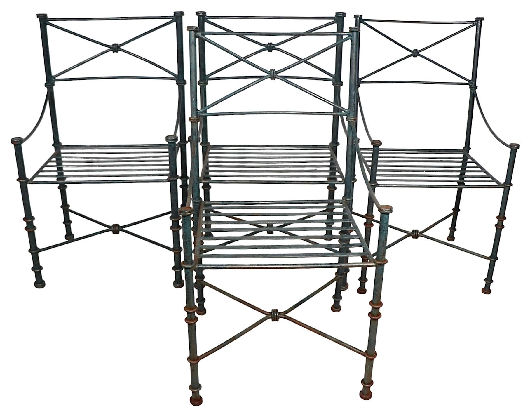 Chic set of  architectural chairs in original faux Verdigris finish, done in the Brutalist, Neo Classical, Antiquity style, after Giacometti. The chairs feature tubular metal frames with decorative rings, curved X form backs, and slatted seats. All