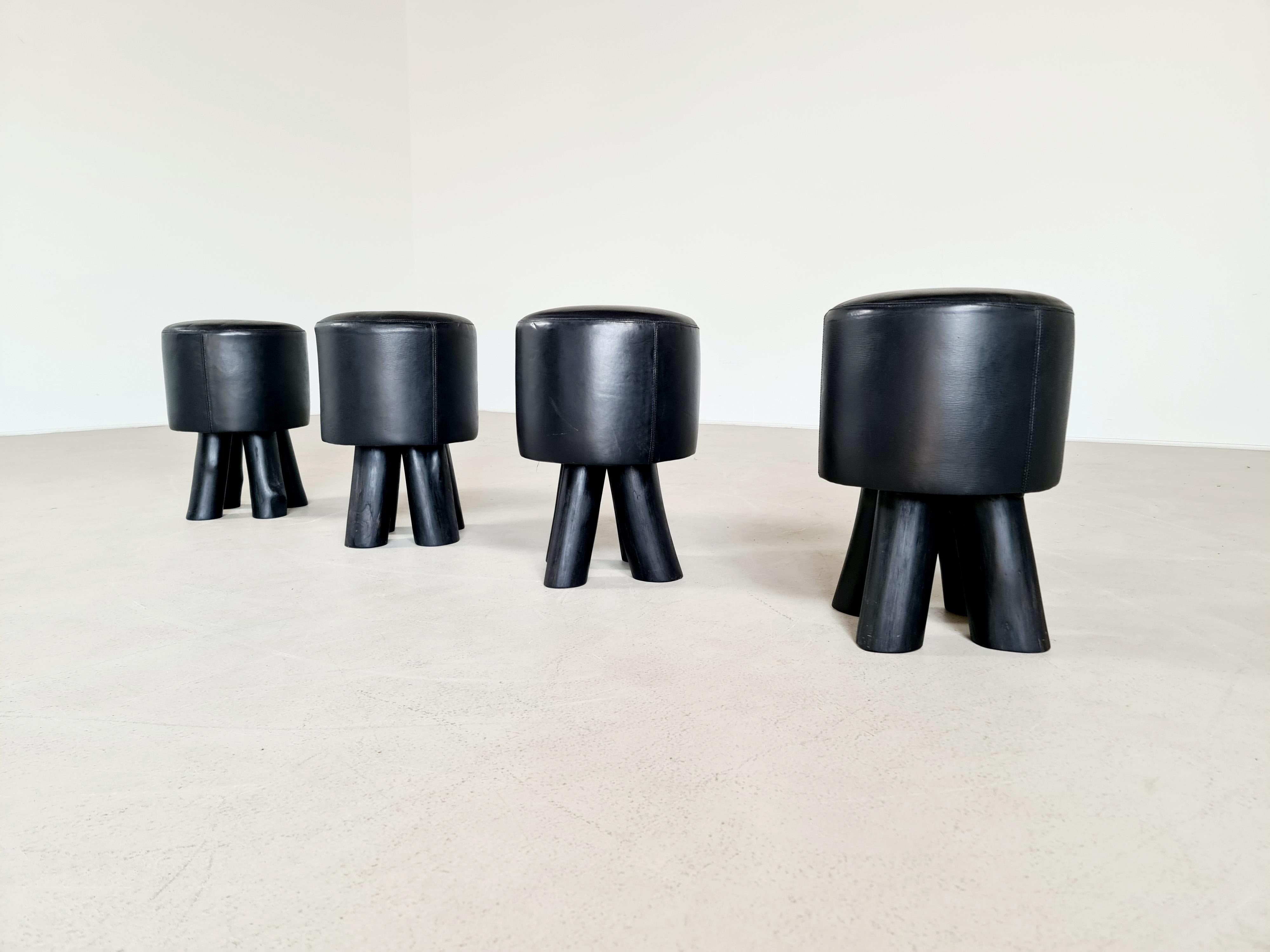 Set of 4 Brutalist stools in solid wood and black leather, Belgium, around 1970s. Can also be used at a dining table because of the 45cm heigtht.