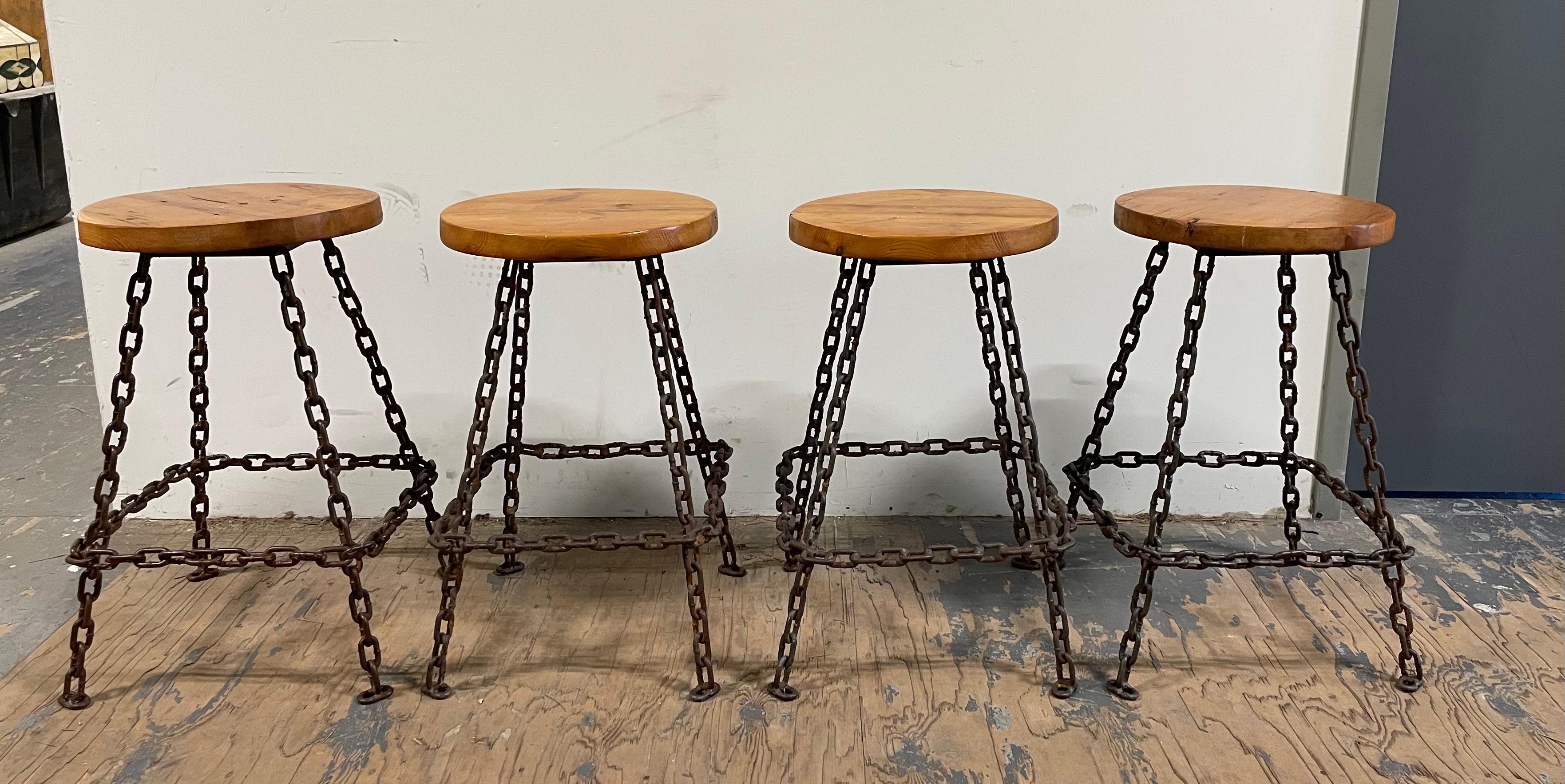 Set of four brutalist bar stools made of welded marine chain and varnished wood seats. Oxidation on metal as shown on pictures. Sturdy and in great condition. Some scuffs and scratches to seats.