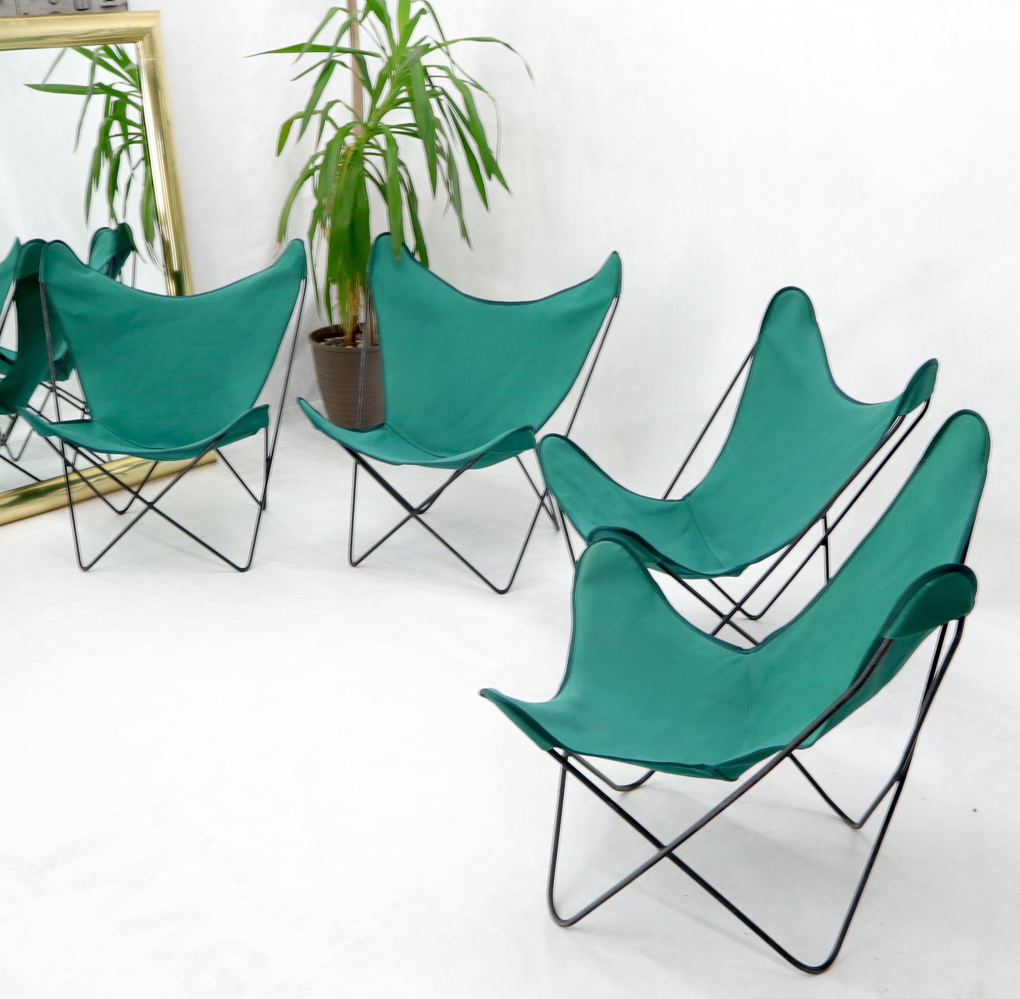 Set of four Mid-Century Modern butterfly sling lounge stacking outdoor suitable chairs.