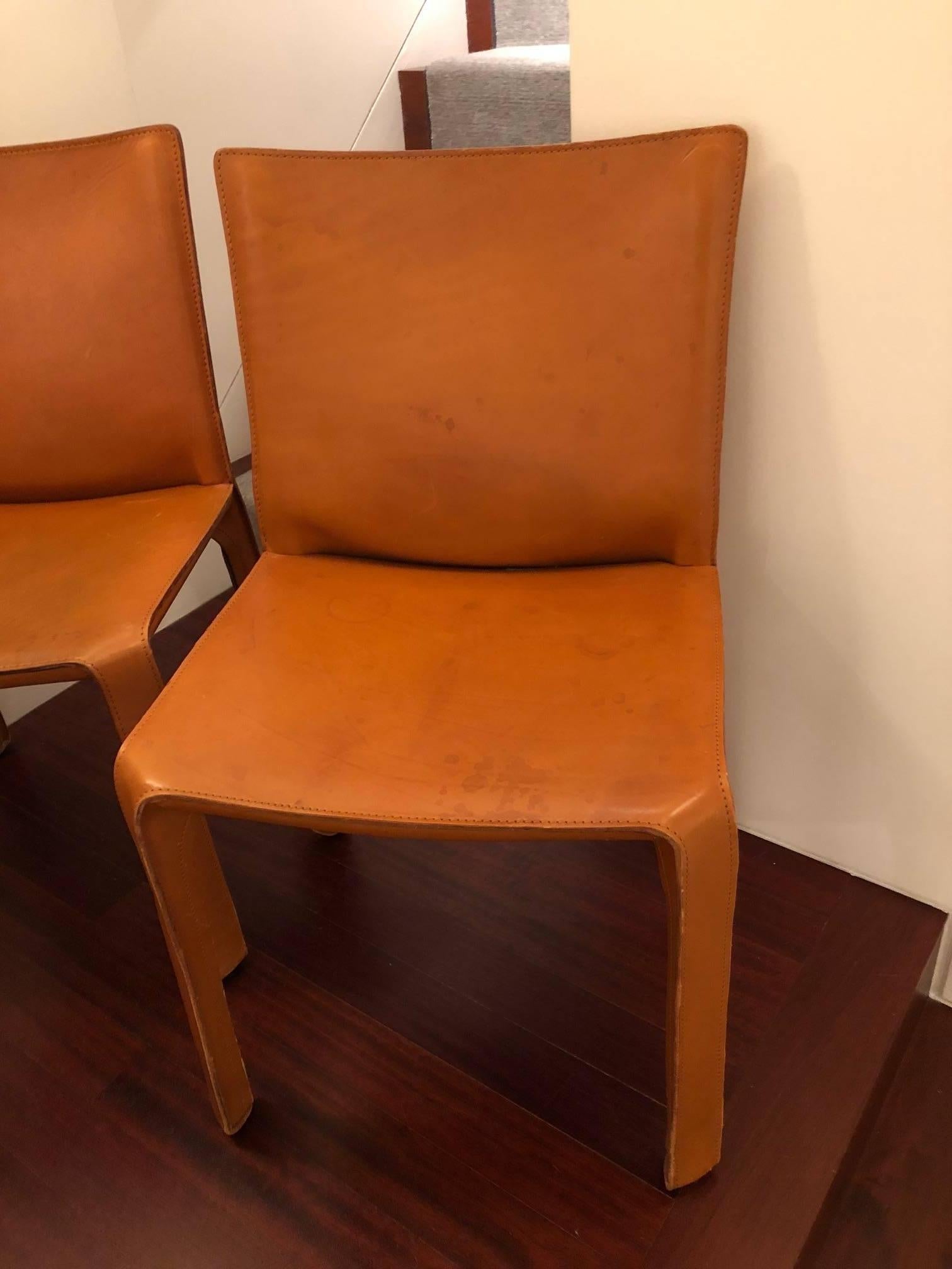 Set of four vintage CAB 412 chairs 
Mario Bellini for Cassina
tan leather.

The Cab chair was conceived by the architect and designer Mario Bellini in 1977. Cassina produced a skeleton in tubular steel and stretched leather which is then