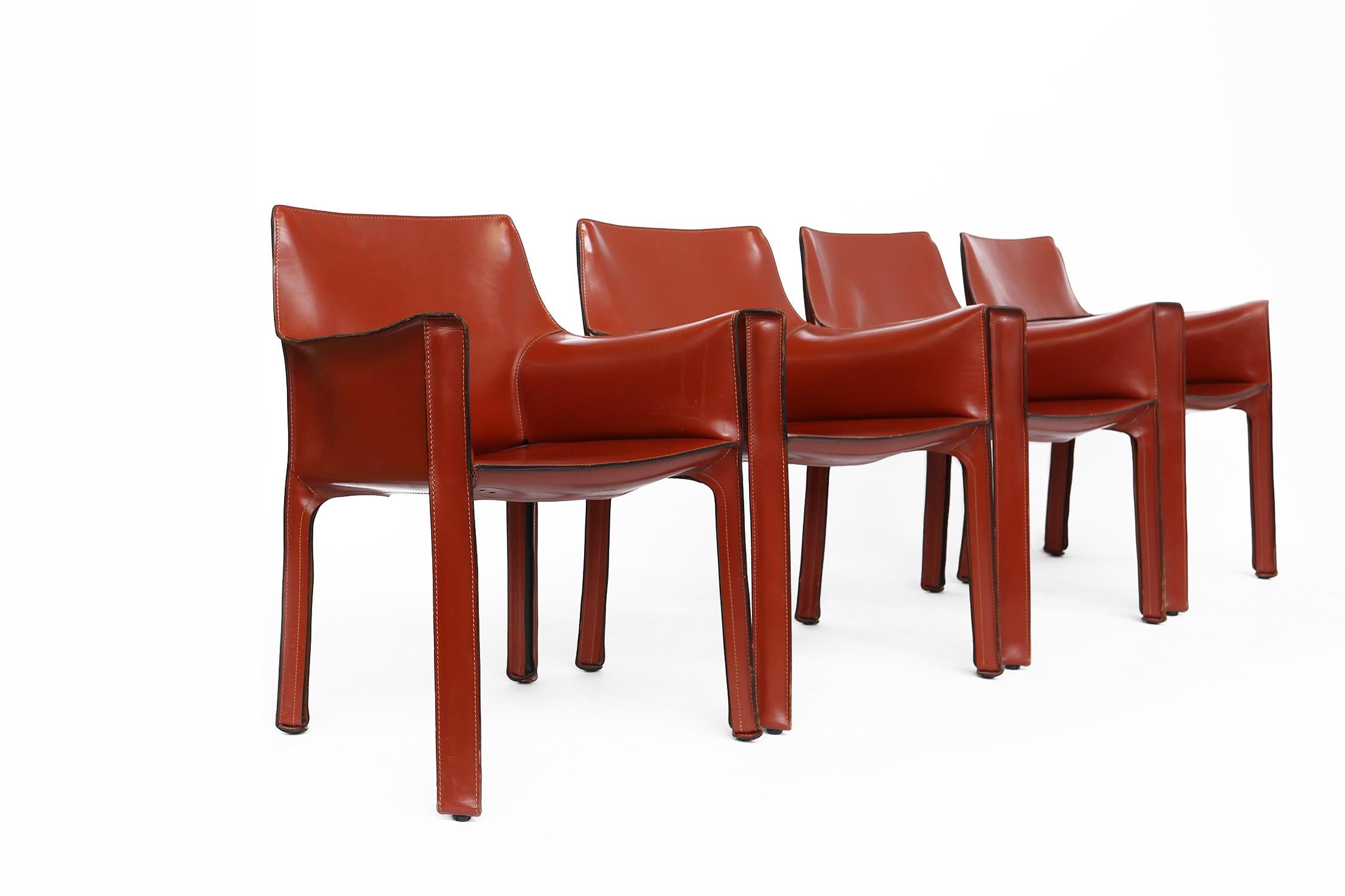 Set of four Cab 413 armchairs in burgundy leather by Mario Bellini for Cassina.
These chairs are built up with a tubular frame over which thick saddle leather is fitted. The leather skin is kept in place with zippers on the inside legs.
A