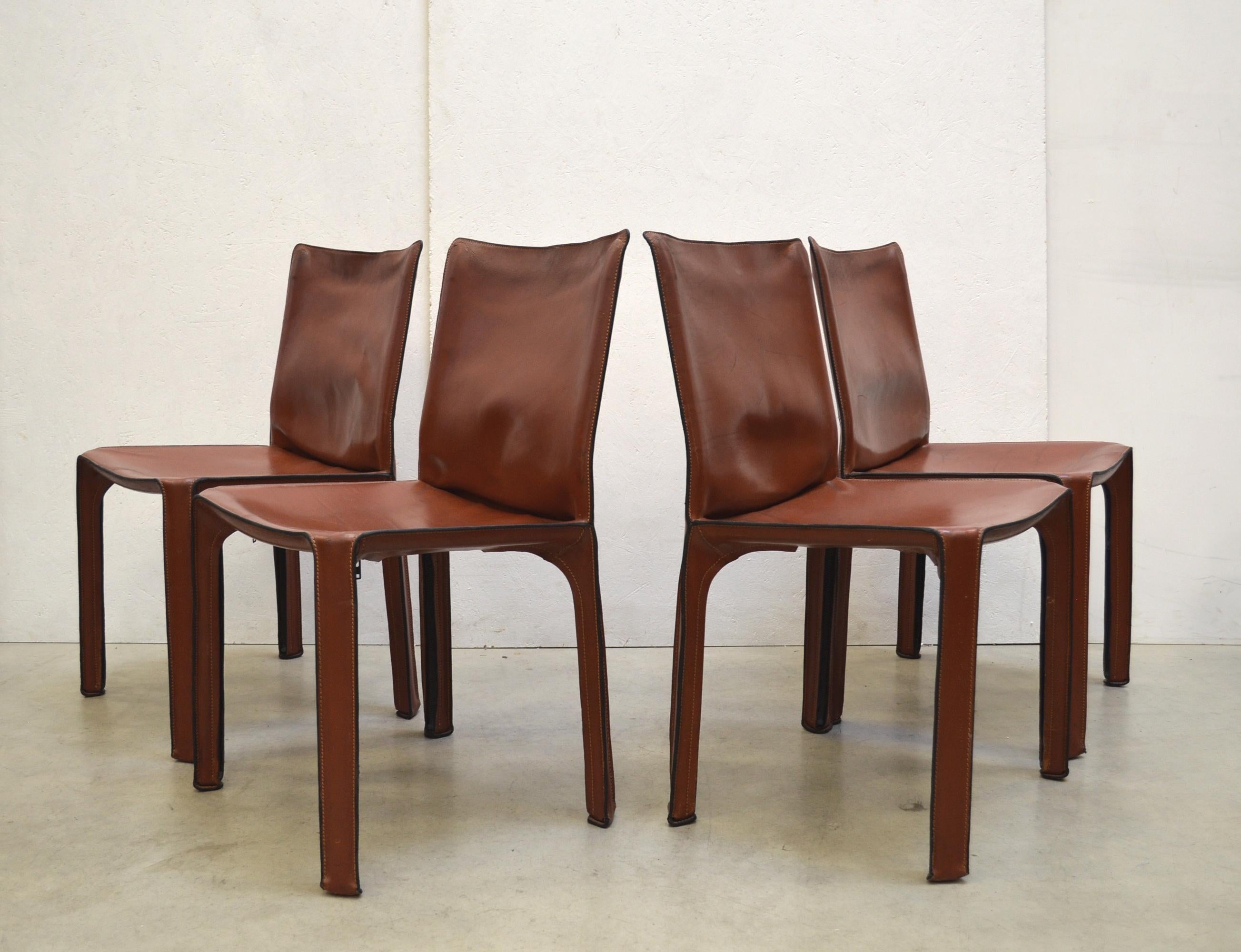 Set of 4 iconic cab chair model 412 by Mario Bellini for Cassina.
These cab chairs coming from the 1st series production.
Original made in Italy.

Full patinated Cognac saddle leather which comes in nice condition with some patina.

Timeless