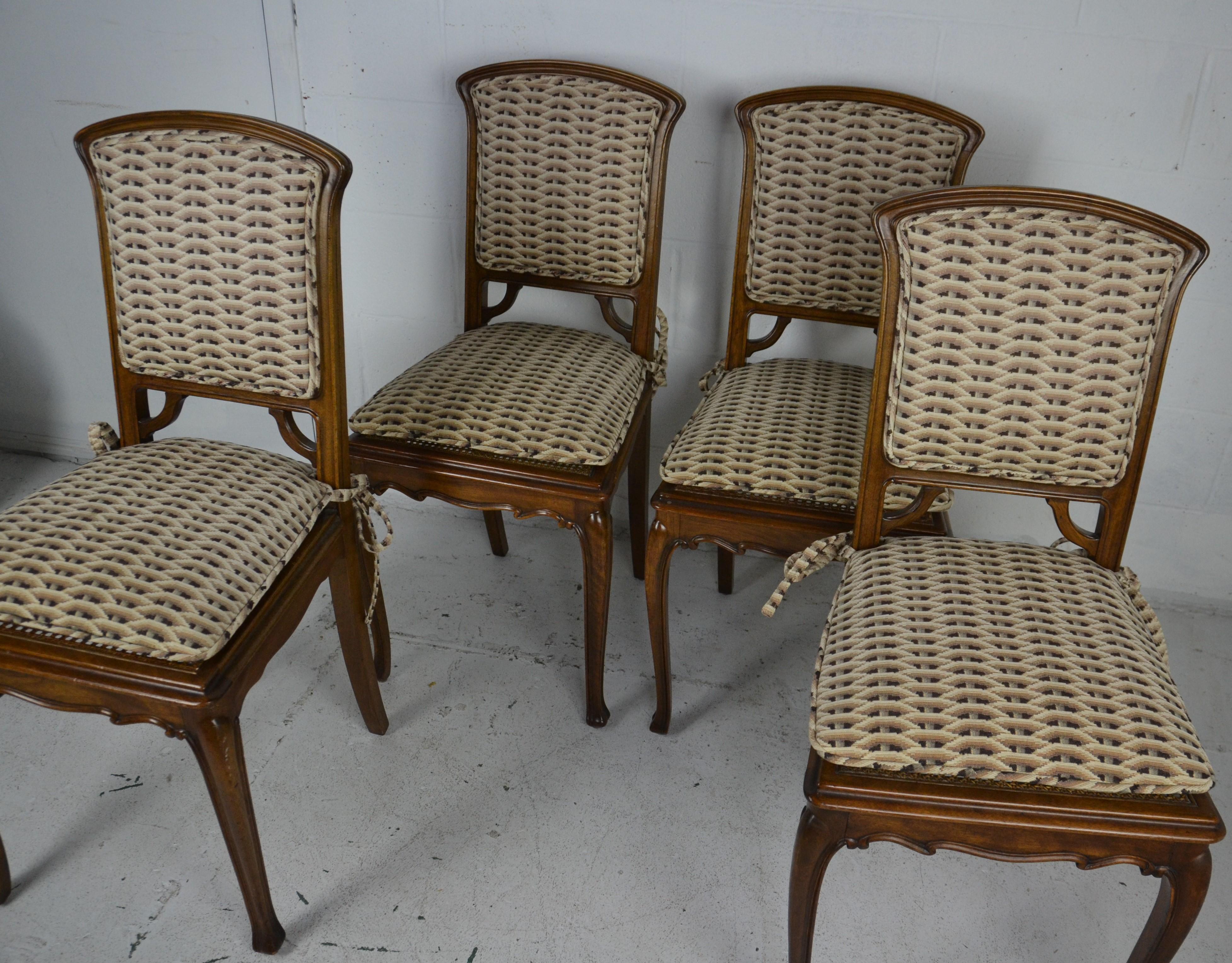 An unusual set of 4 chairs in mahogany with finely carved legs and front rail. The backs in the Art Nouveau style.