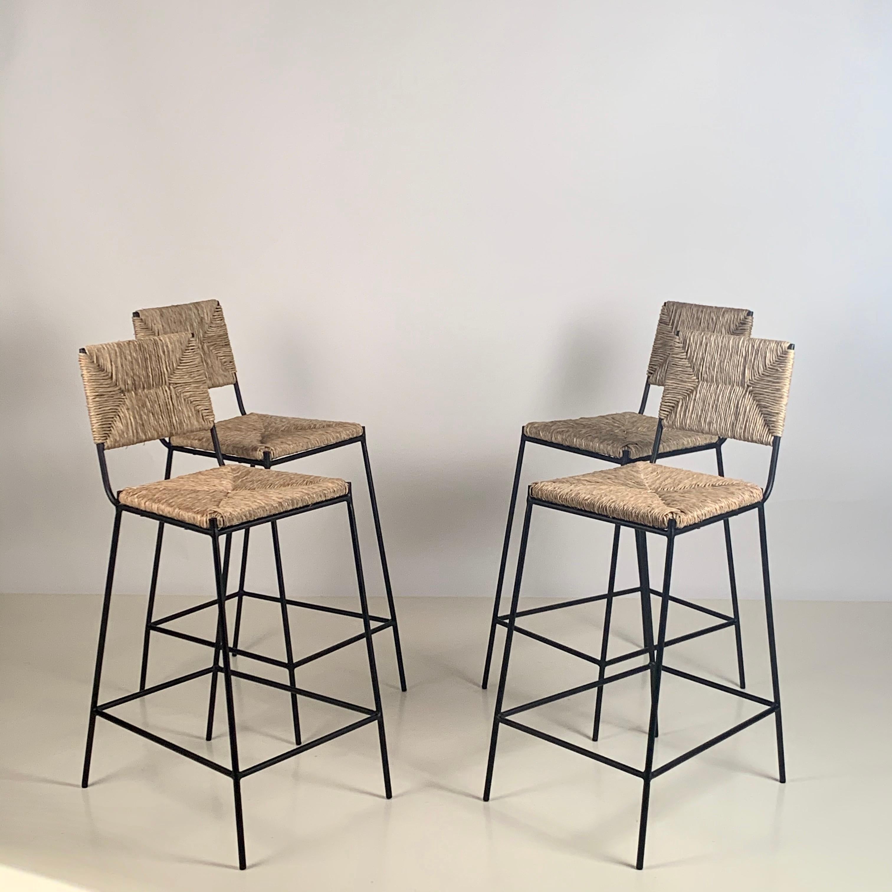 Set of 4 'Campagne' counter height stools by Design Frères.

Chic combination of slender but sturdy and stabile powder coated steel frames with handwoven rush seats and backs. Extra support under the rush seat for durability. Durable plastic caps