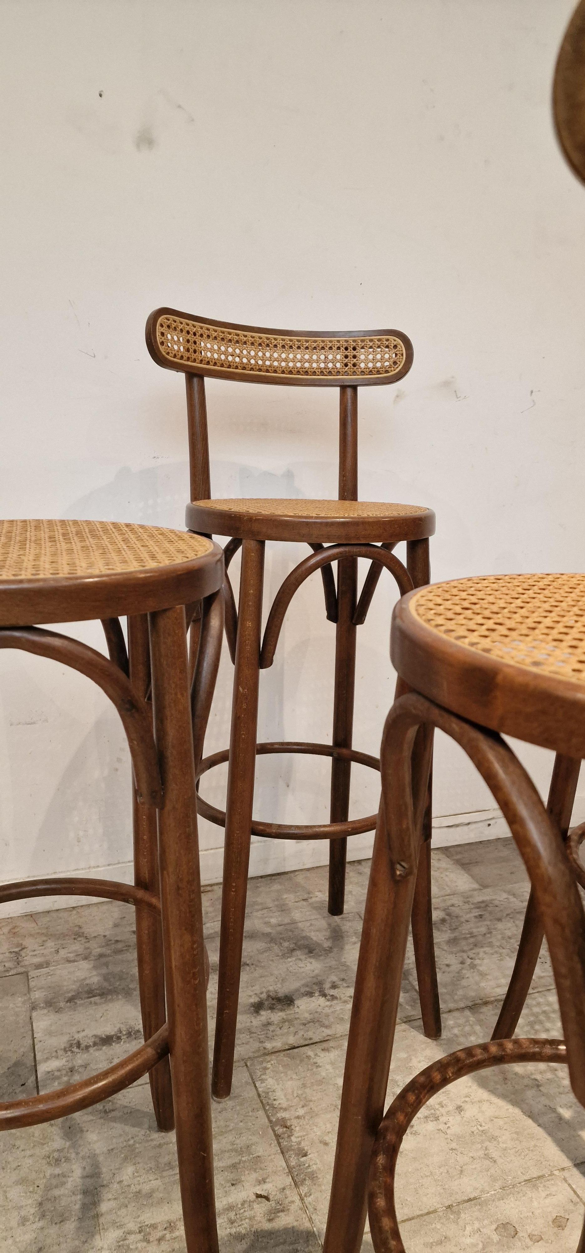 Set of 4 Canned, wooden barstools, French 1980s.