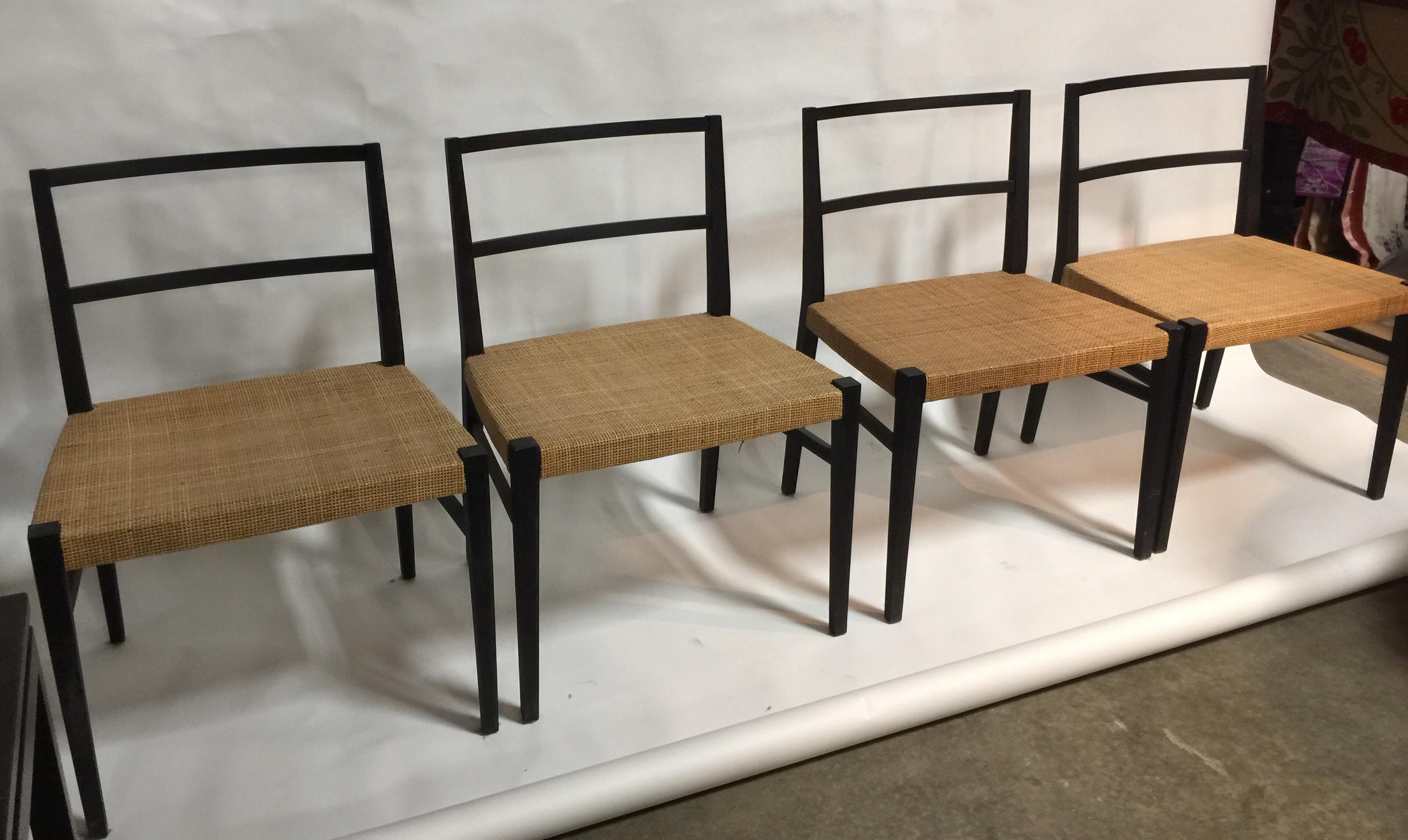 A set of four (4) ebonized wood dining chairs wth cane seats by Cappellini. Italy, circa 2000. Siged with paper label to underside of each chair. Originally ordered from Cappellini for an Eats Hampton, New York residence designed by Thom