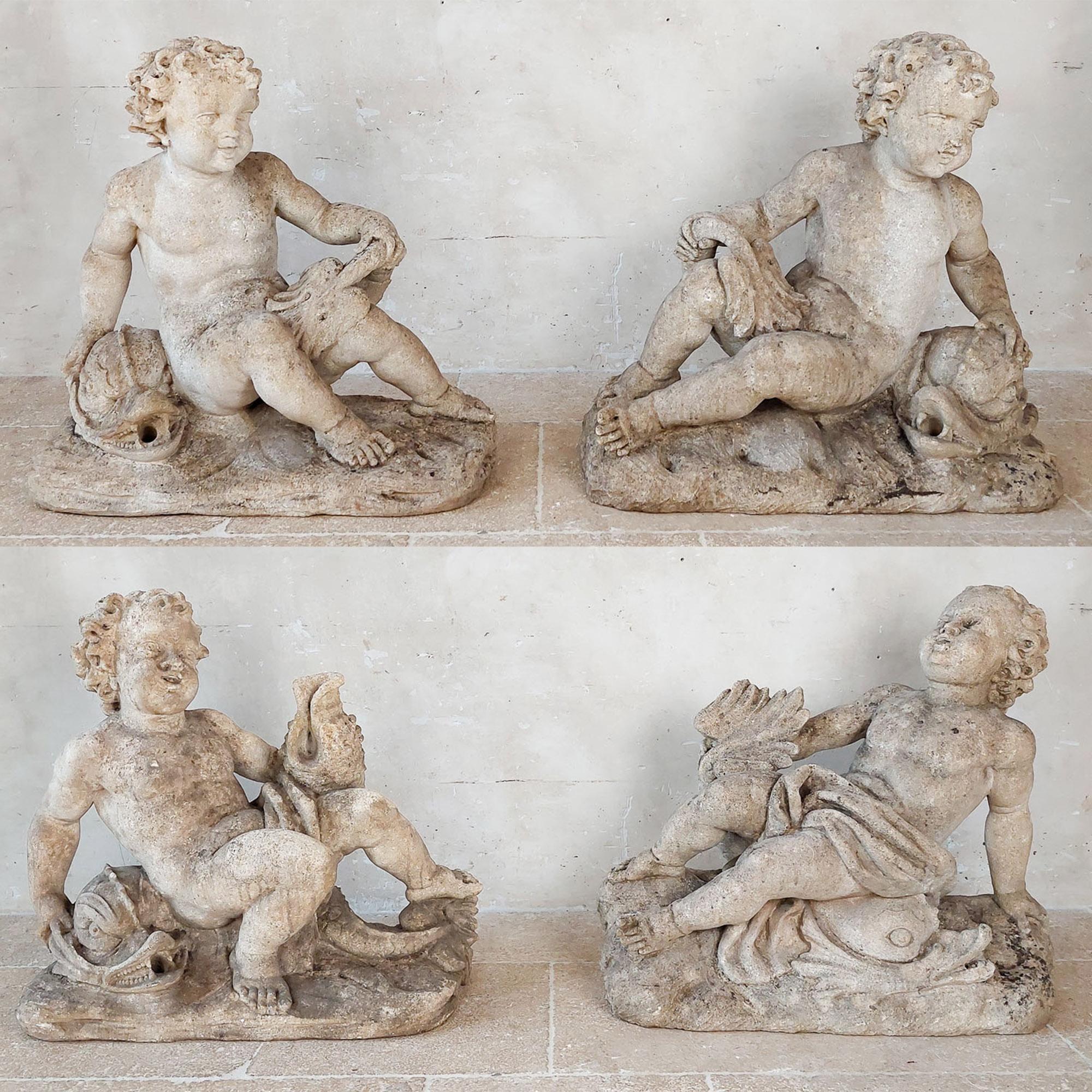 Set of 4 carved limestone fountain putti seated with dolphins, the dolphins with a small hole to be used as spouts. These sculptures are also usable as decorative objects indoors isntead of in your garden or perhaps around an indoor pool.

the